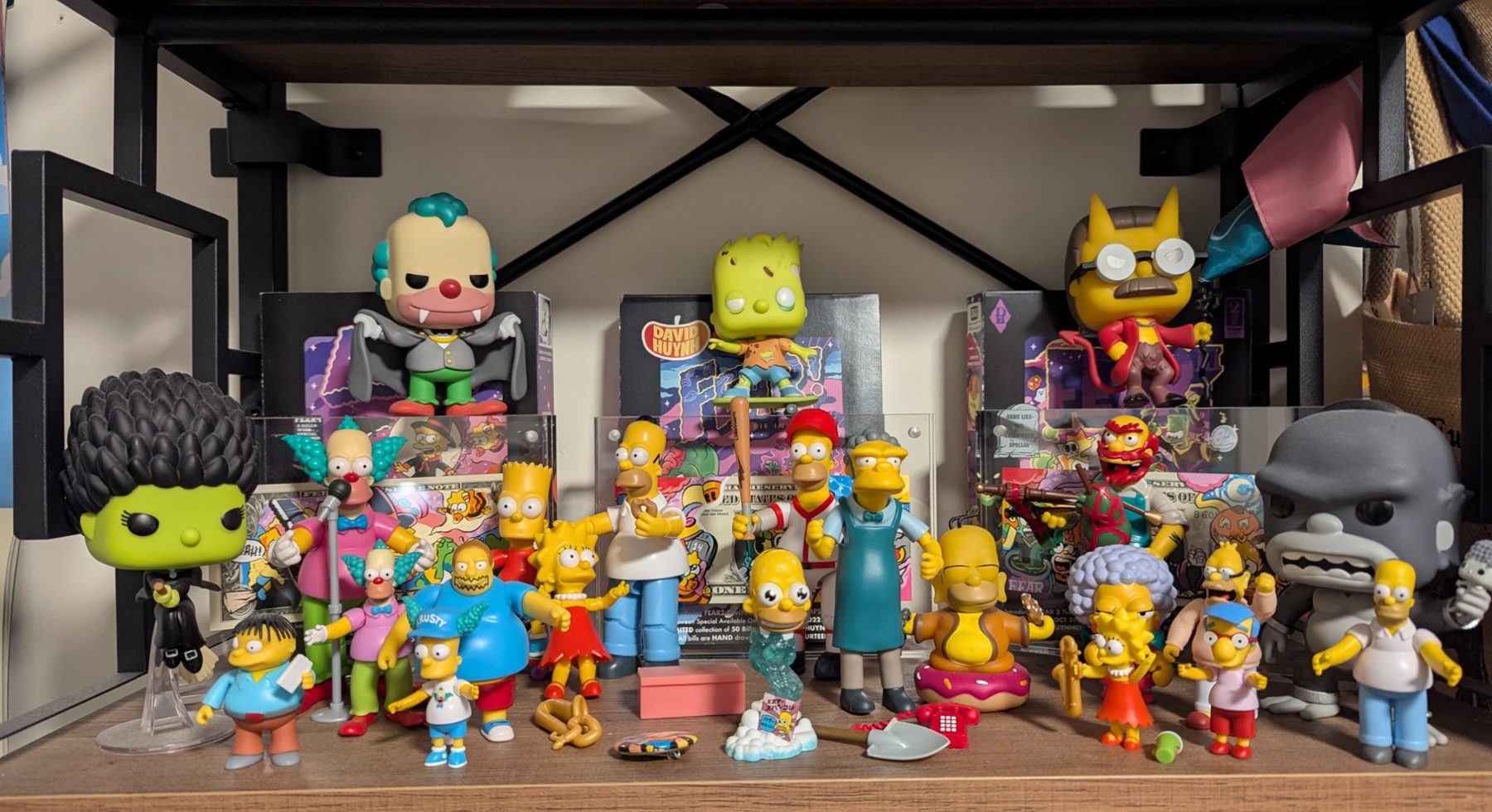 Part of my Simpsons shelf: Treehouse of Horror figures, Krusty, Moe, Comic Book Guy, Milhouse and a lot of Homers