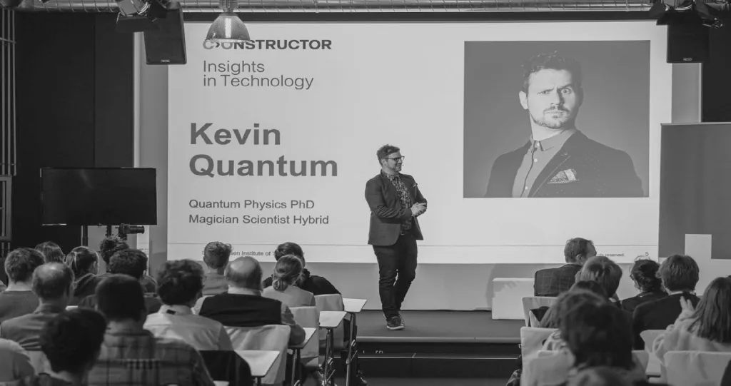 Speaker presenting on stage at a conference