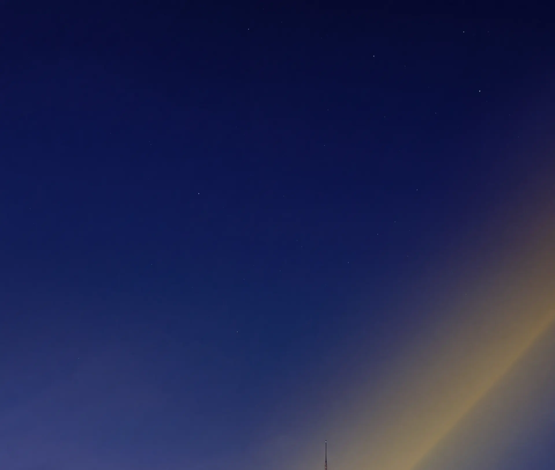 The Dubai skyline under a deep blue night sky
