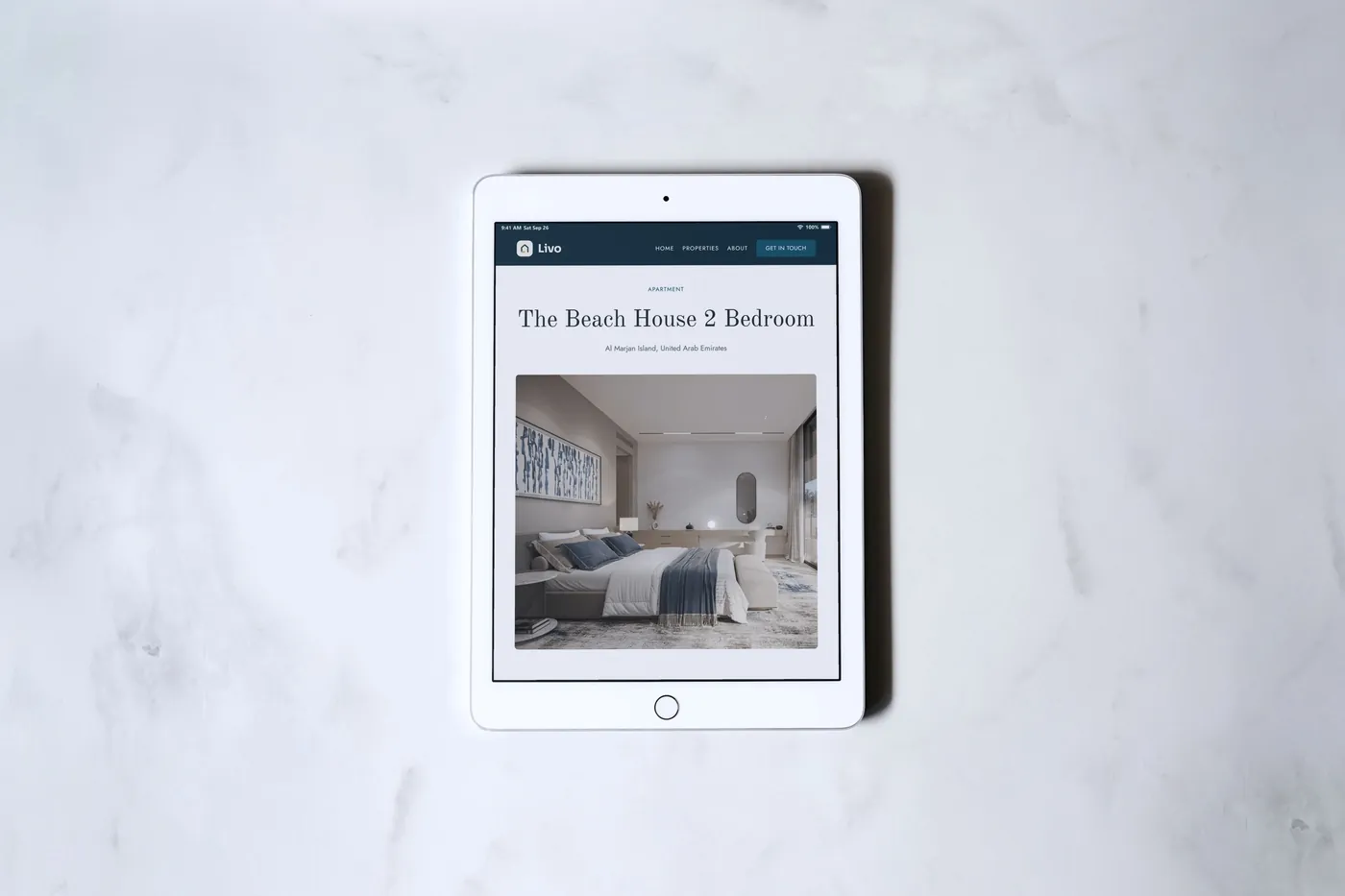 A Livo concept residence page on a white iPad lying on white marble.