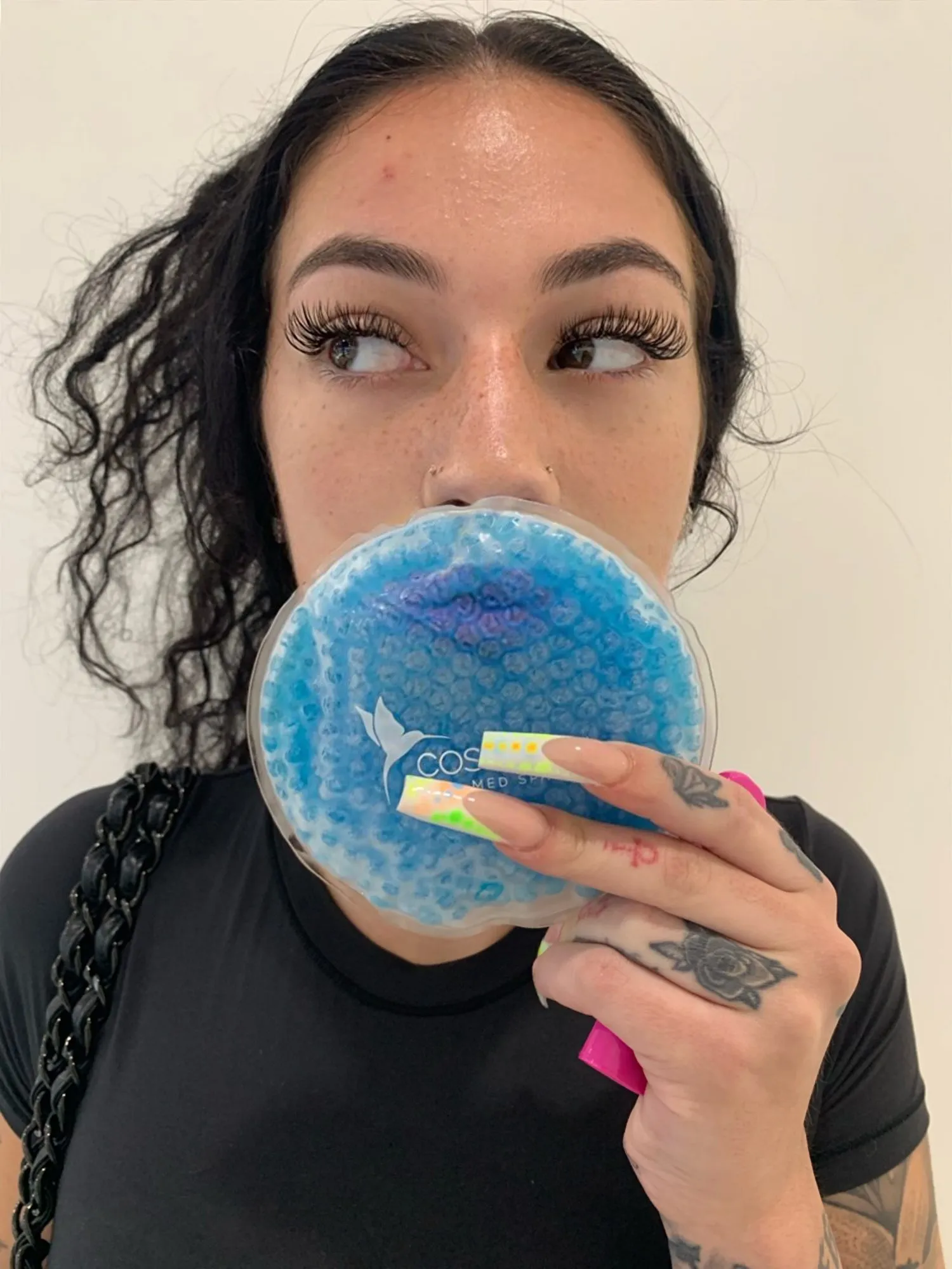 Bhad Bhabie holding a Cosmetica Med Spa ice pack after lip filler in Boca Raton