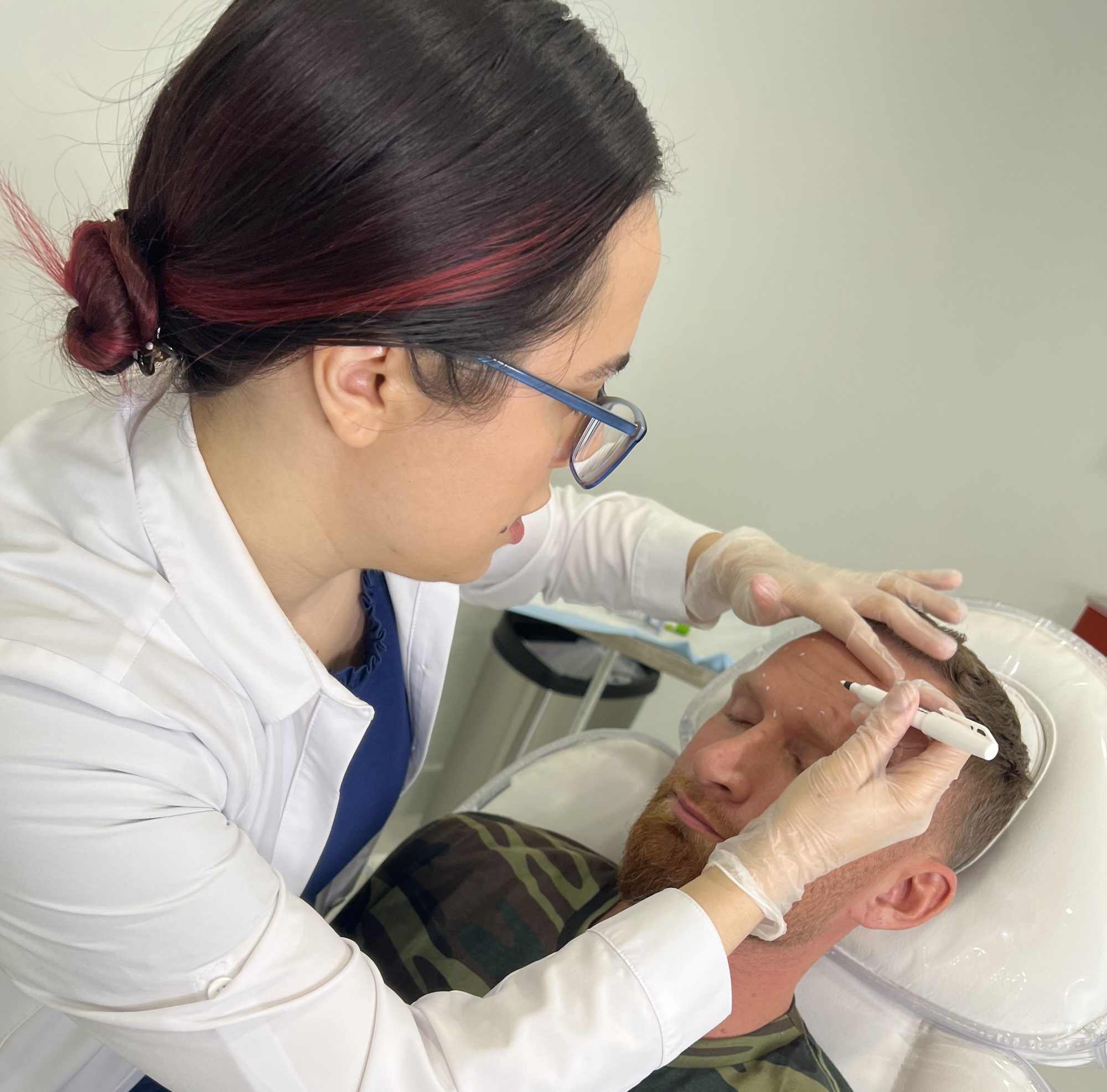 Provider marking injection points for men's Botox at Cosmetica Med Spa