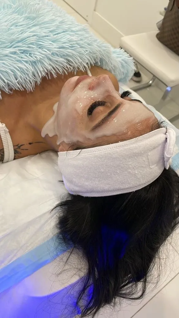 Client wearing a hydrating mask during a facial at Cosmetica Med Spa