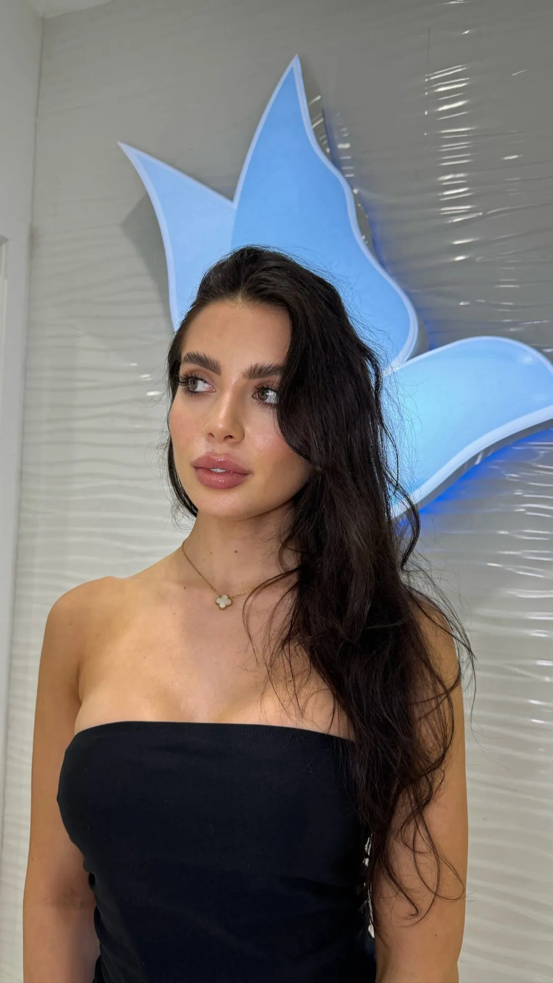 Rocio Baeza in front of the Cosmetica Med Spa logo in Boca Raton
