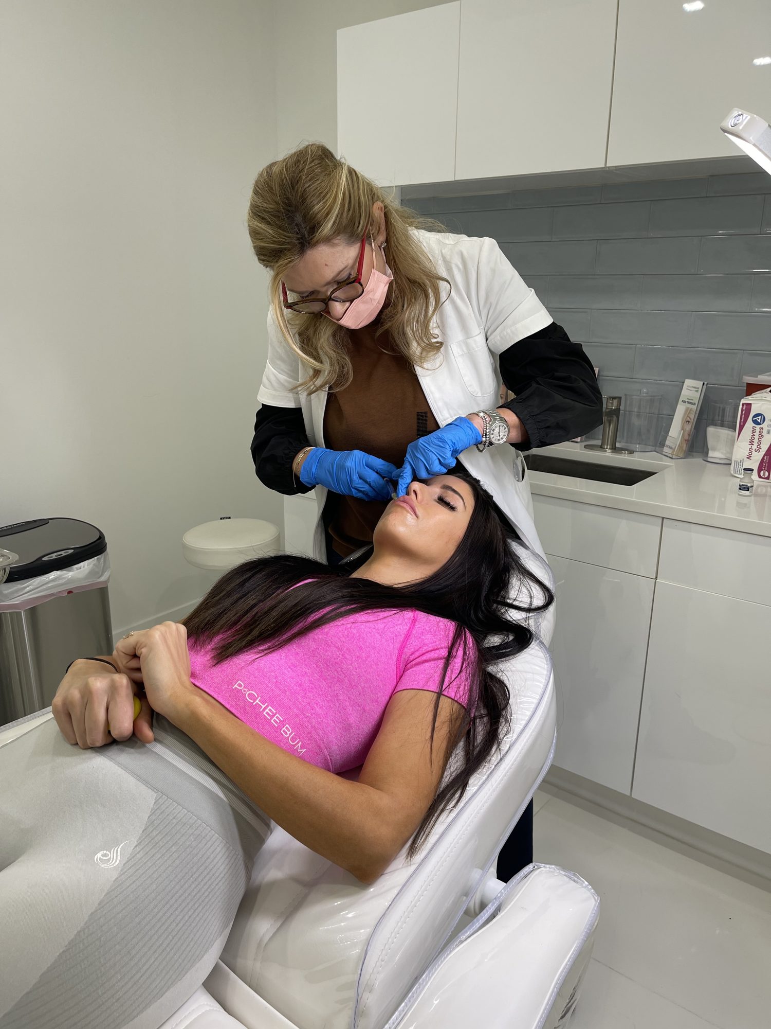 Provider injecting lip filler for a client at Cosmetica Med Spa in Boca Raton