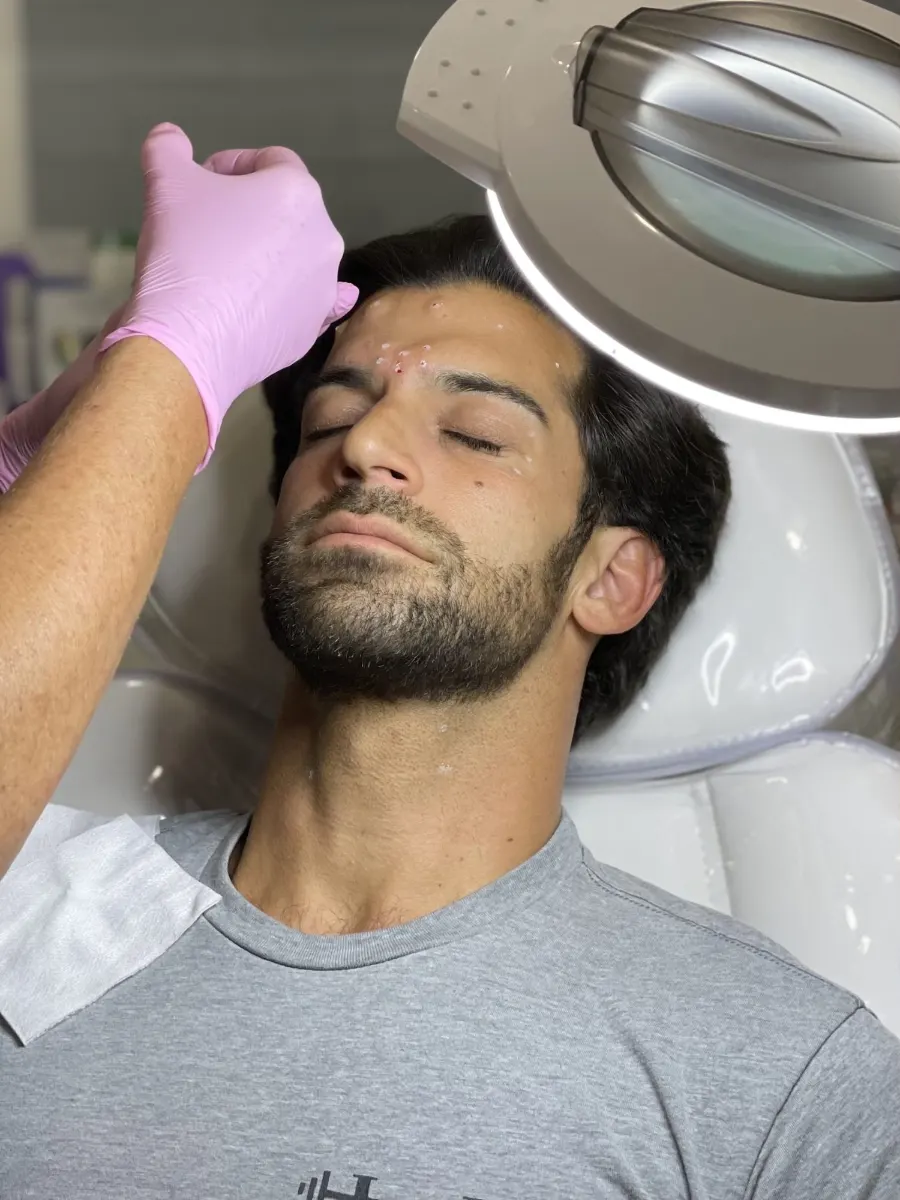 Man receiving Botox injections in the forehead at Cosmetica Med Spa