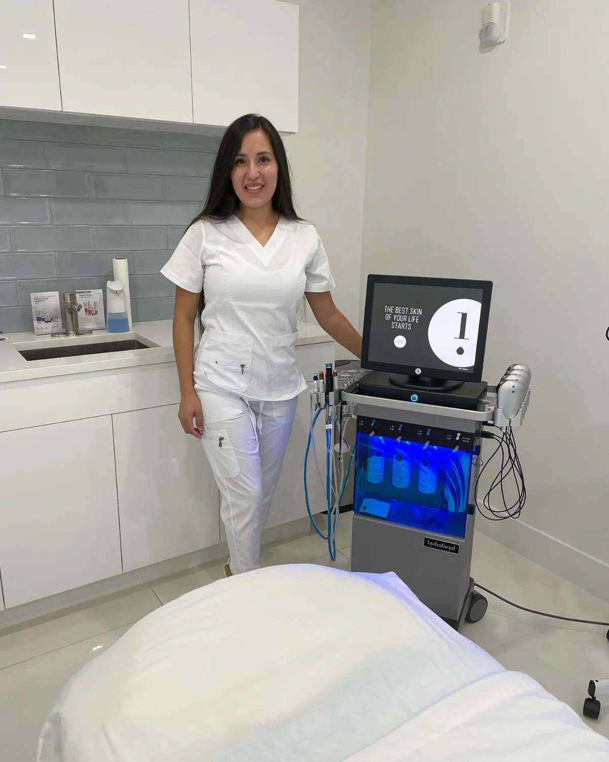 Provider with the Hydrafacial machine in a treatment room at Cosmetica Med Spa in Boca Raton
