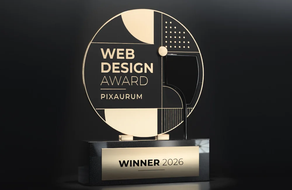 Trophäe der Pixaurum Webdesign Awards: Medaillon in Gold und Schwarz auf Granitsockel mit Schild „Winner 2026“