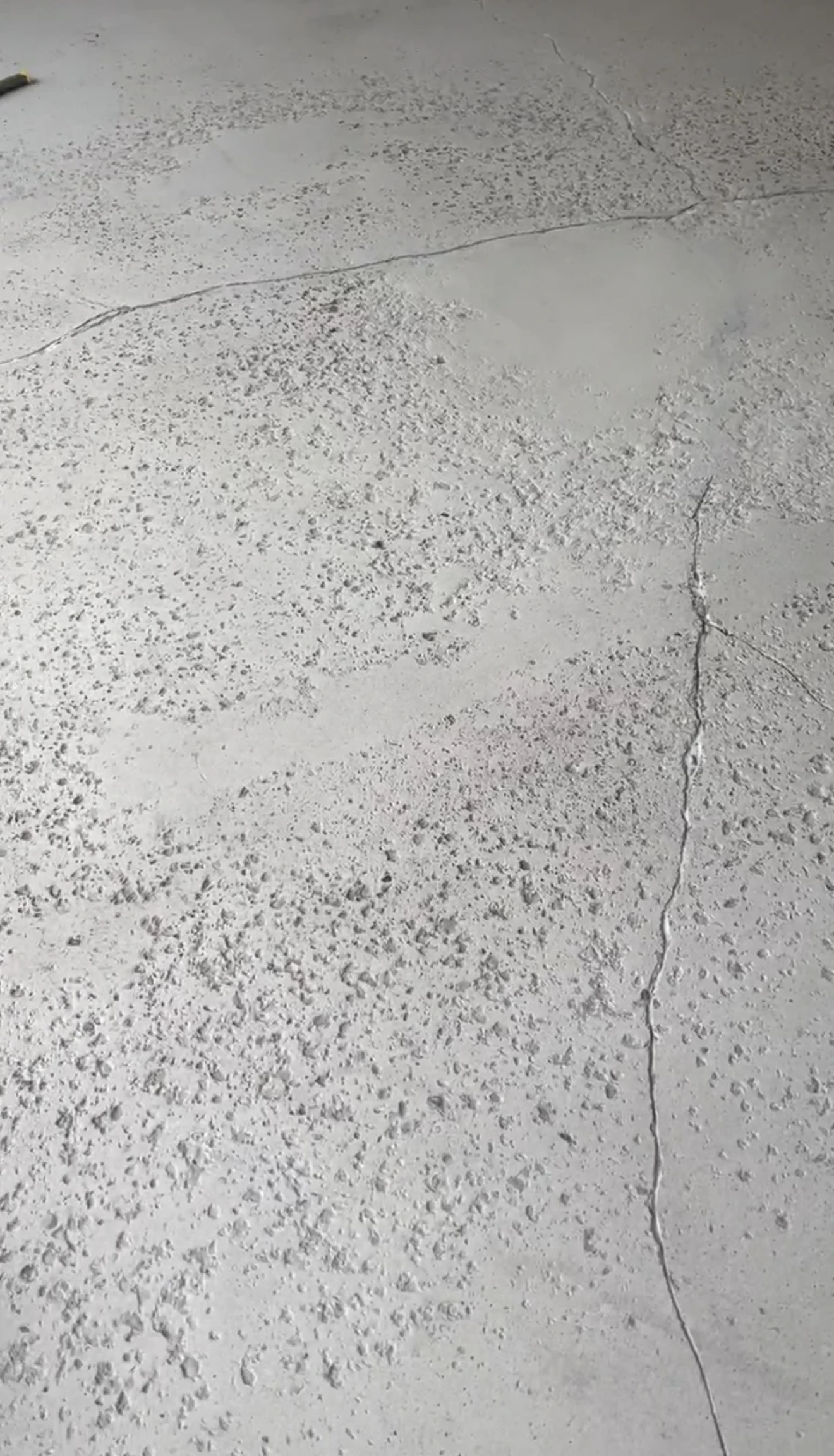 Road salt and slush residue on bare garage concrete in Innisfil, Ontario