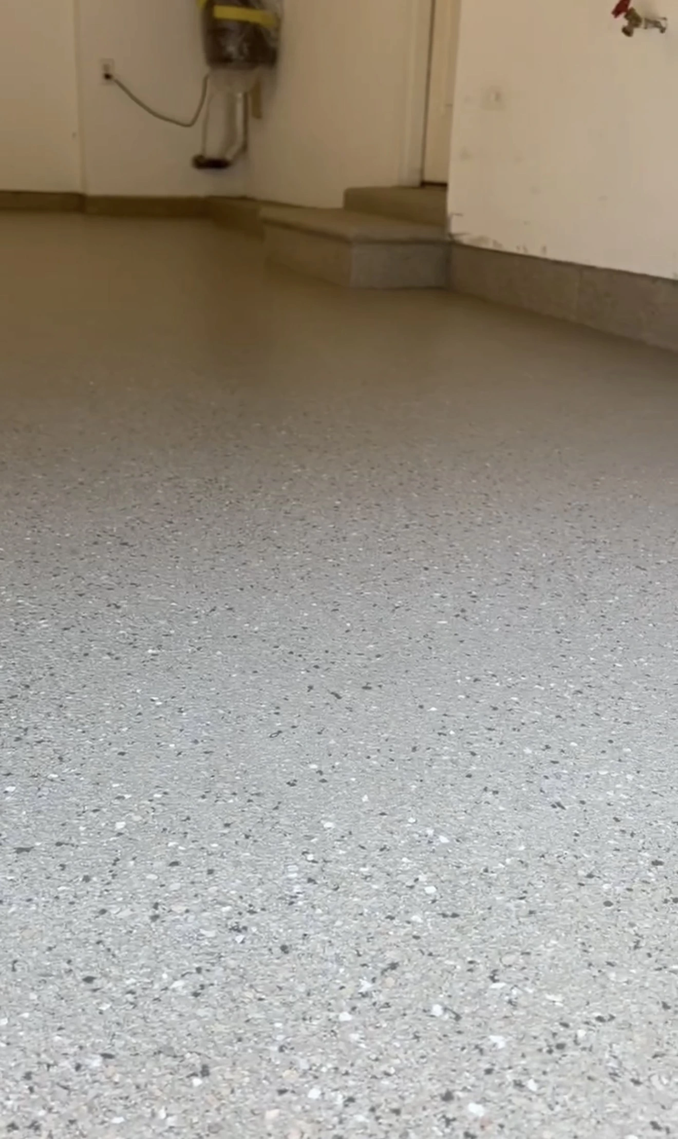 Cracks and worn concrete affected by moisture and road salt in an Innisfil garage