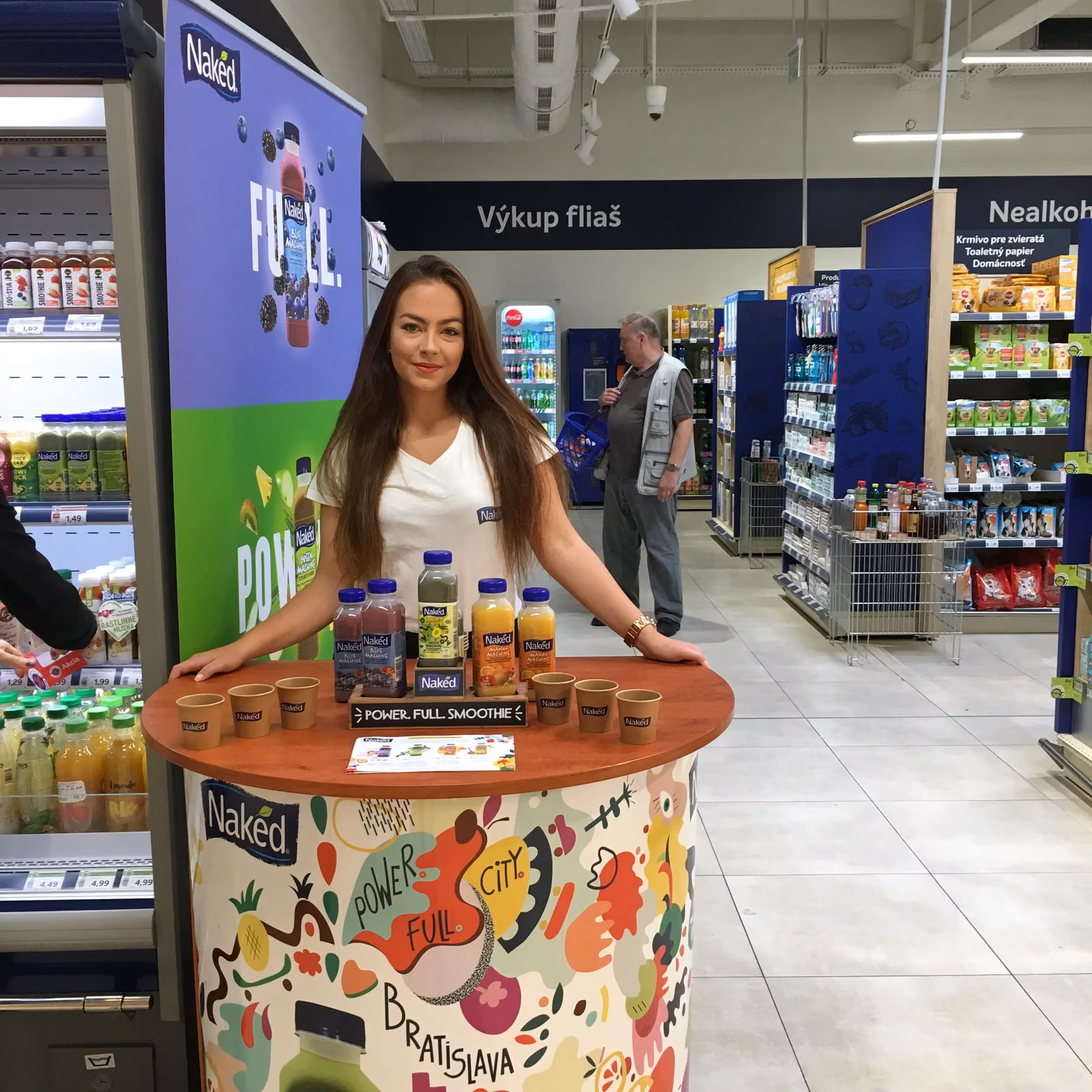 Promoter at a Naked tasting table in a store
