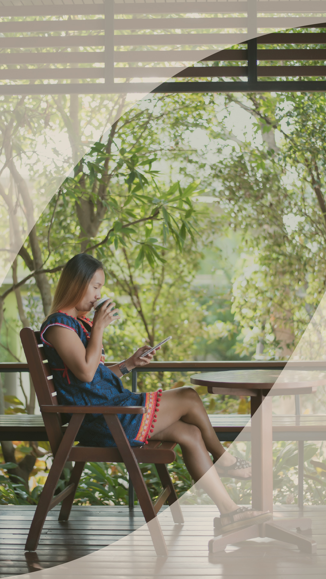 Woman reading her phone at a garden table