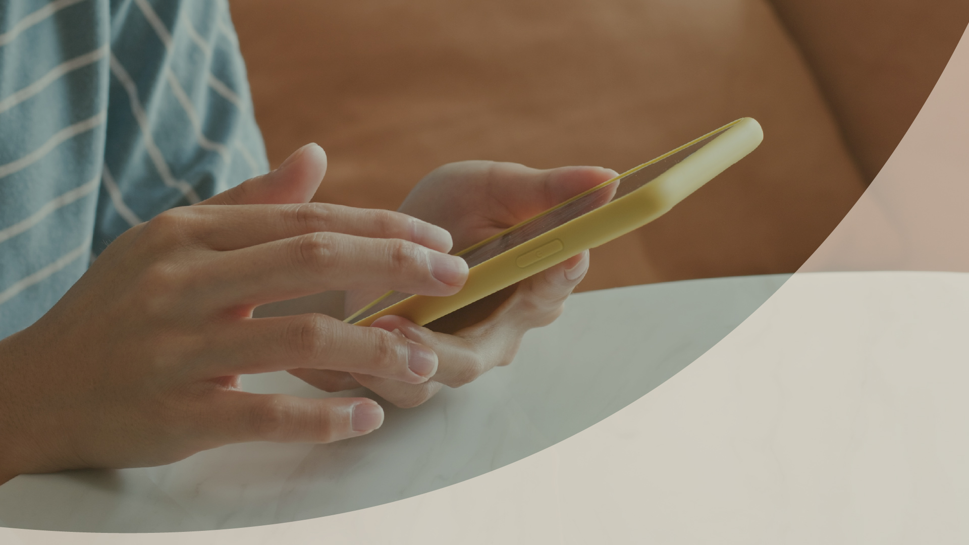 Hands holding a phone and a payment card