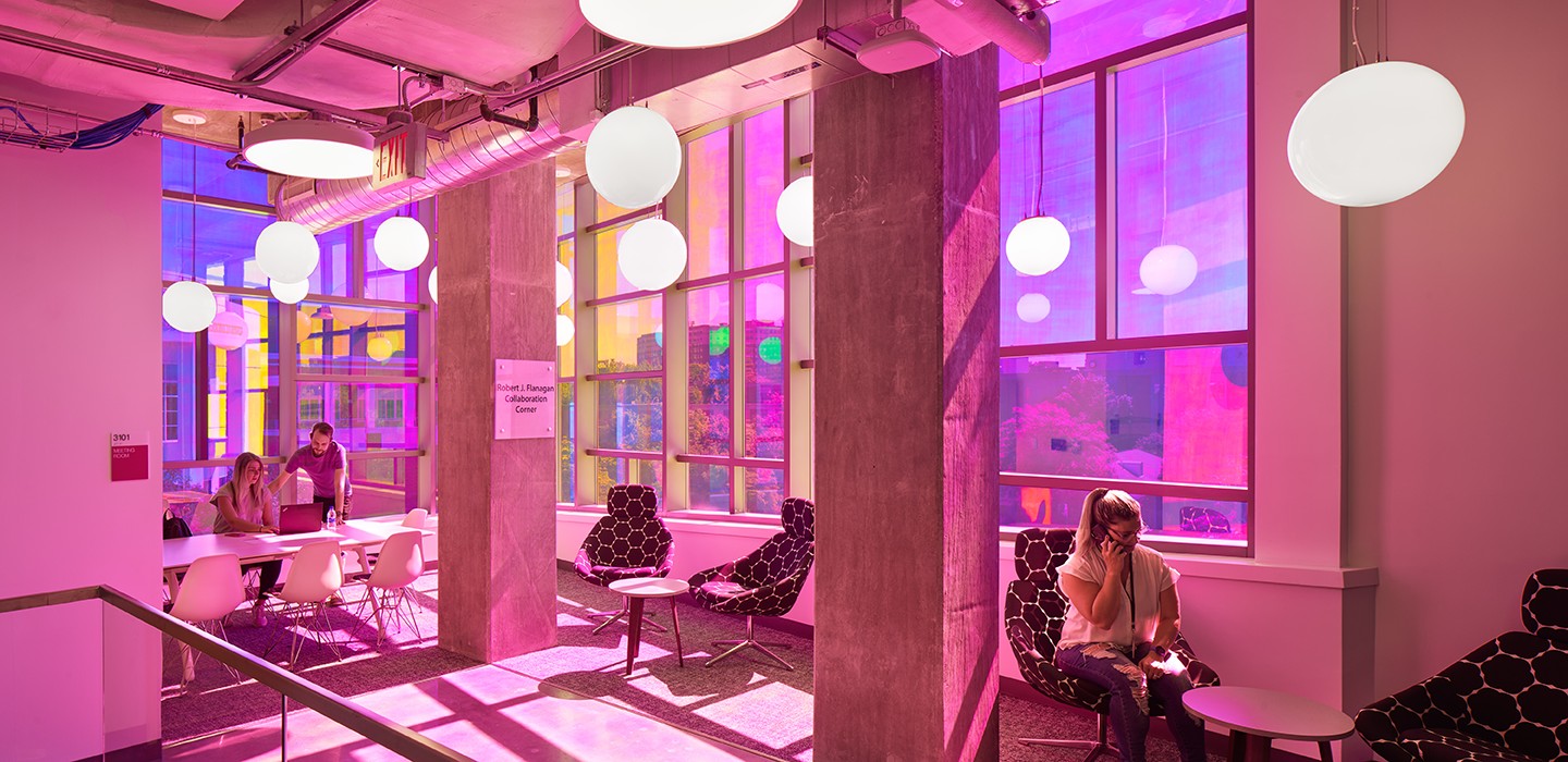 The E. A. Fernandez Idea Factory building, sunlight flaring off its tiled facade and colored-glass window wall