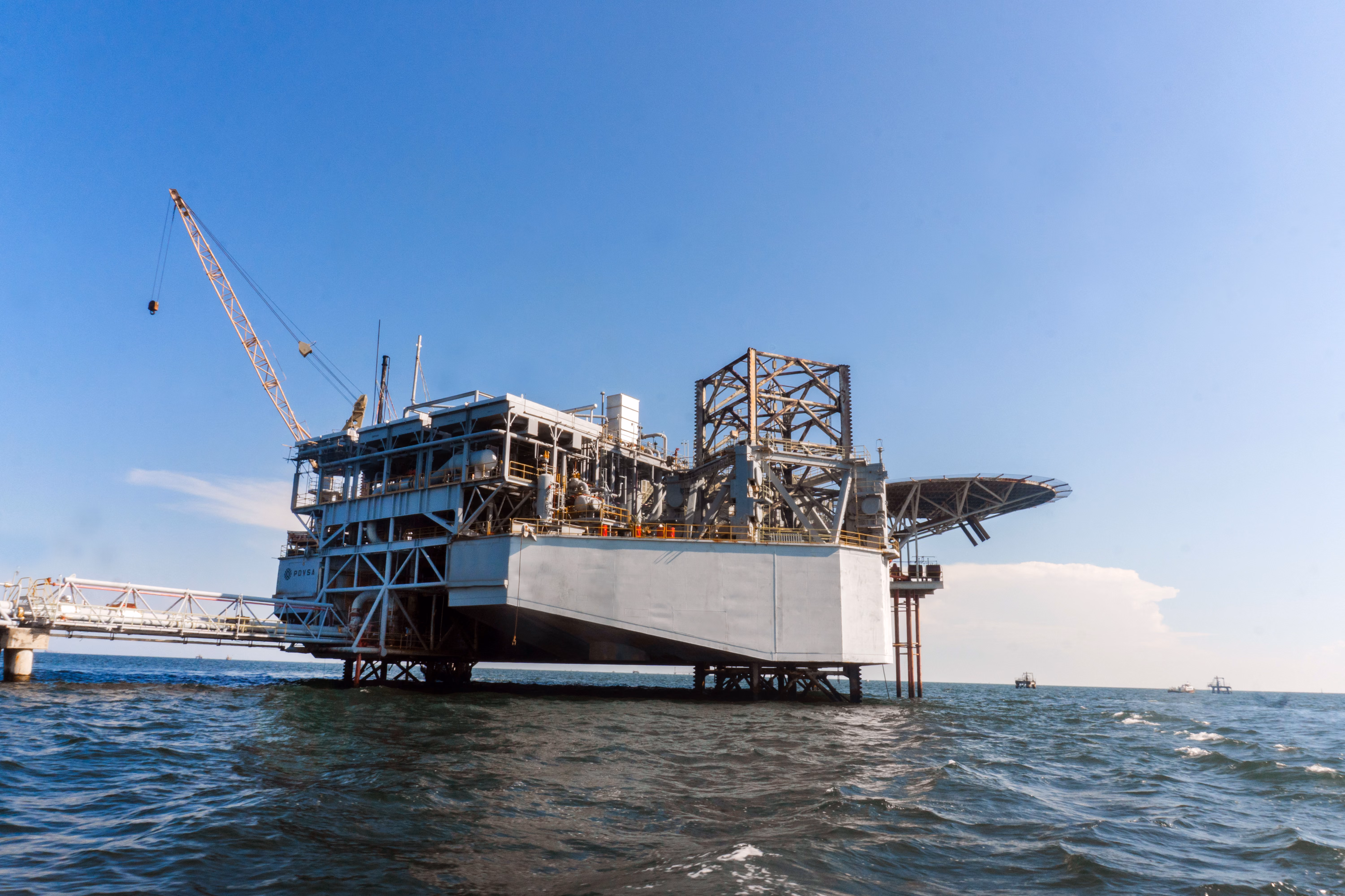 Offshore oil production platform with a crane on open water