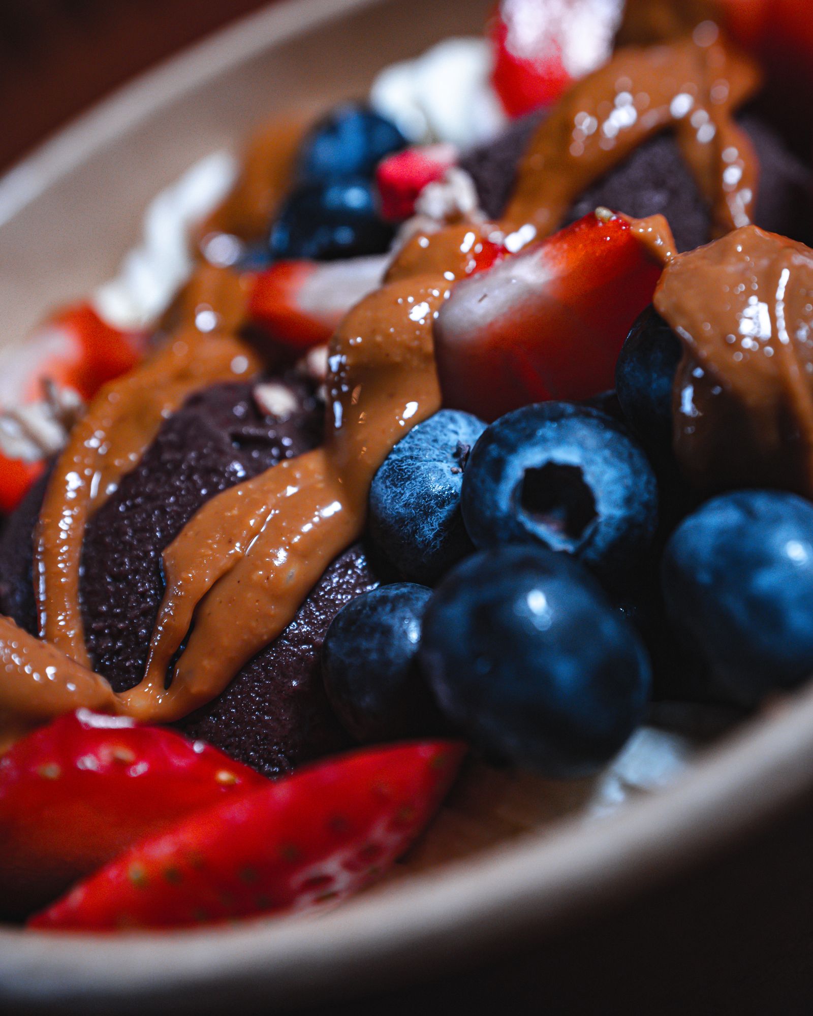 Close-up of smooth organic acai sorbet with blueberries and strawberries