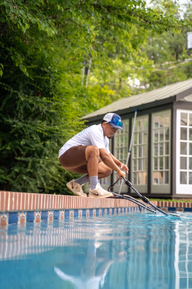 Pool technician testing residential swimming pool water