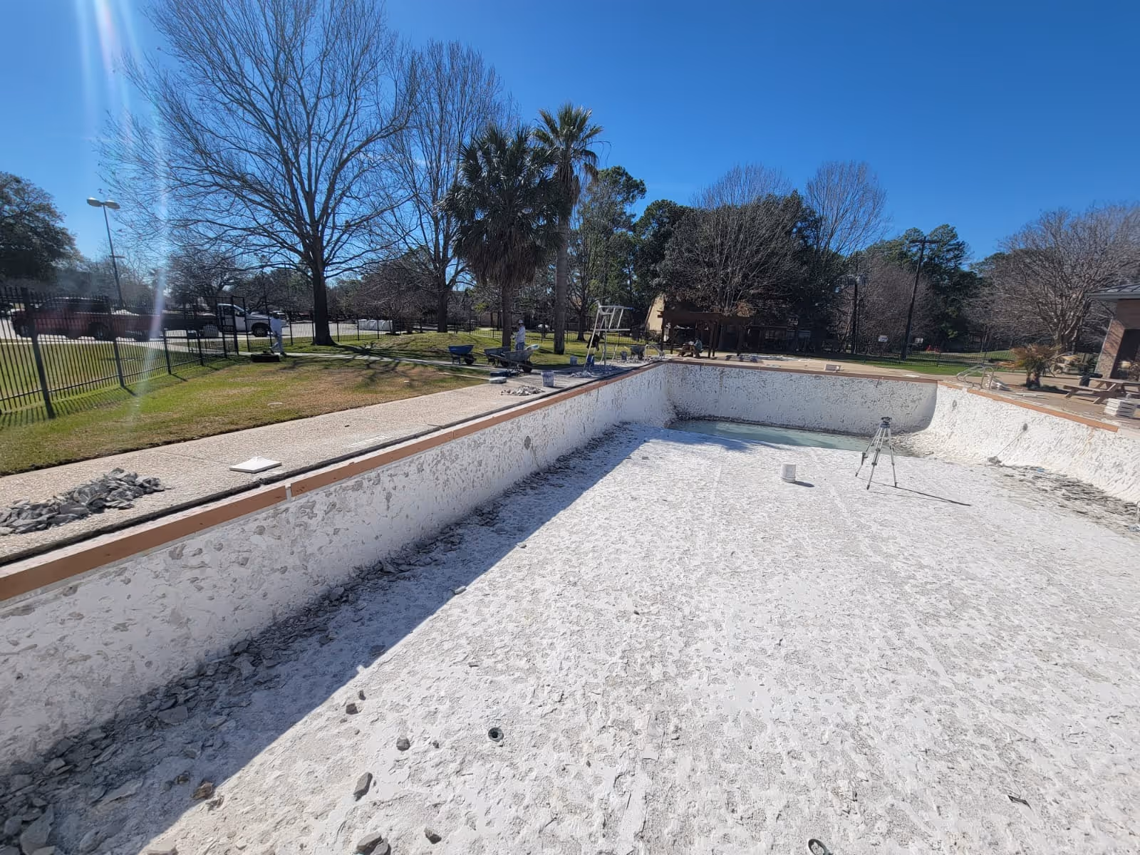 Empty swimming pool undergoing professional renovation