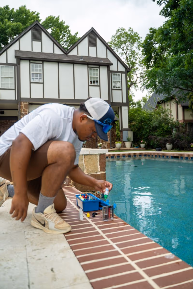 CK Pools technician testing the water quality of a residential swimming pool
