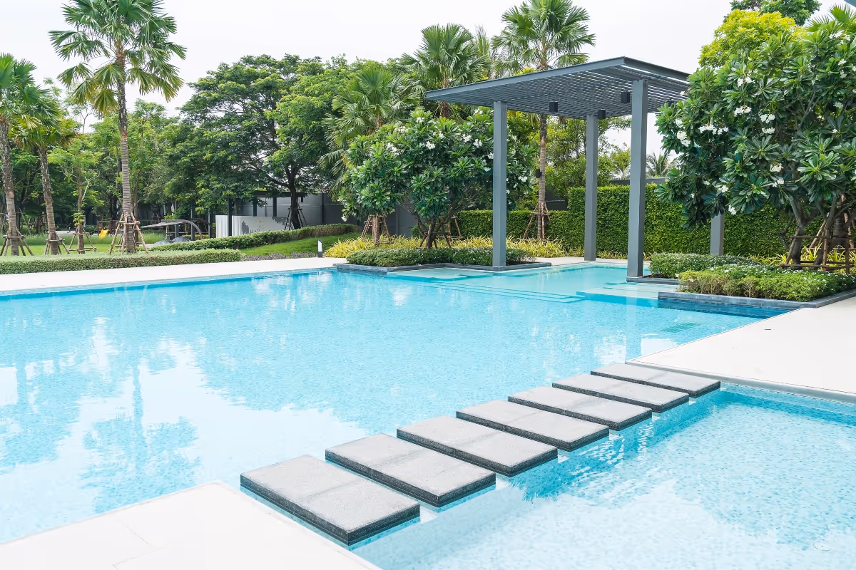 Weekly pool cleaning service crew maintaining a residential backyard pool