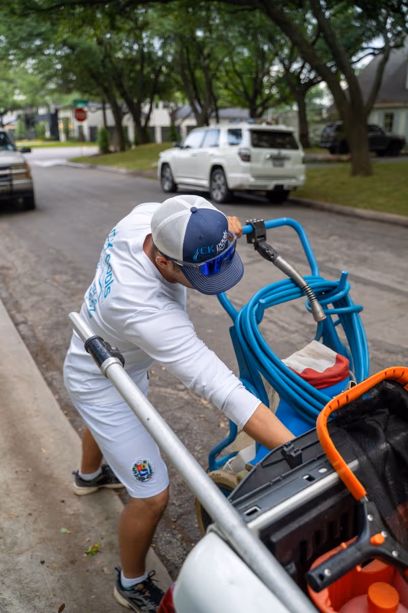 CK Pools technician operating professional pool cleaning equipment