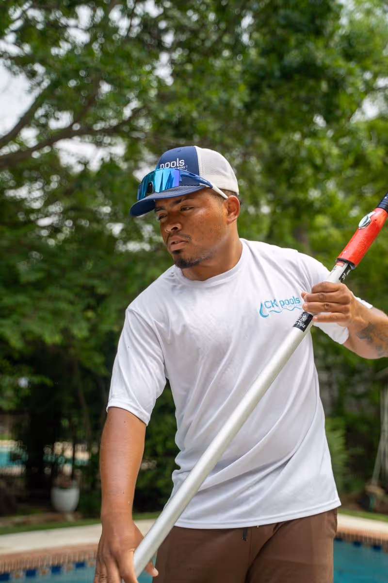 CK Pools technician preparing a pool cleaning brush