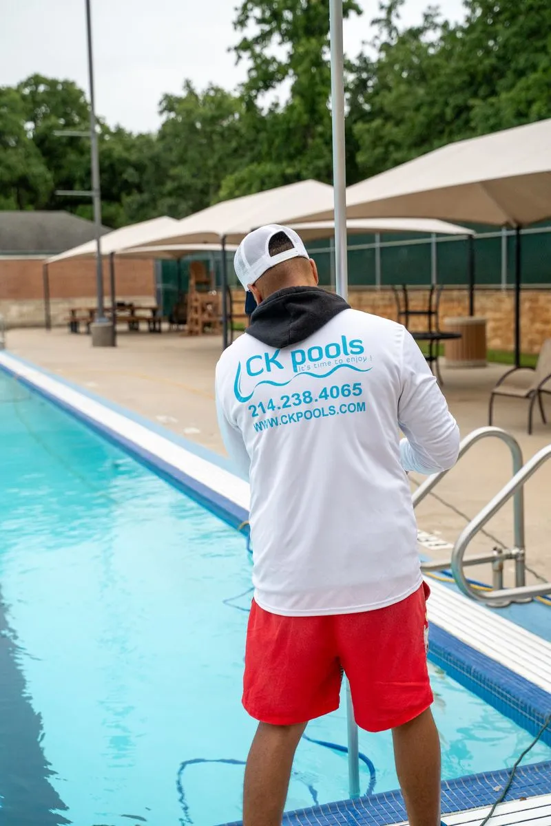 CK Pools professional servicing a residential swimming pool