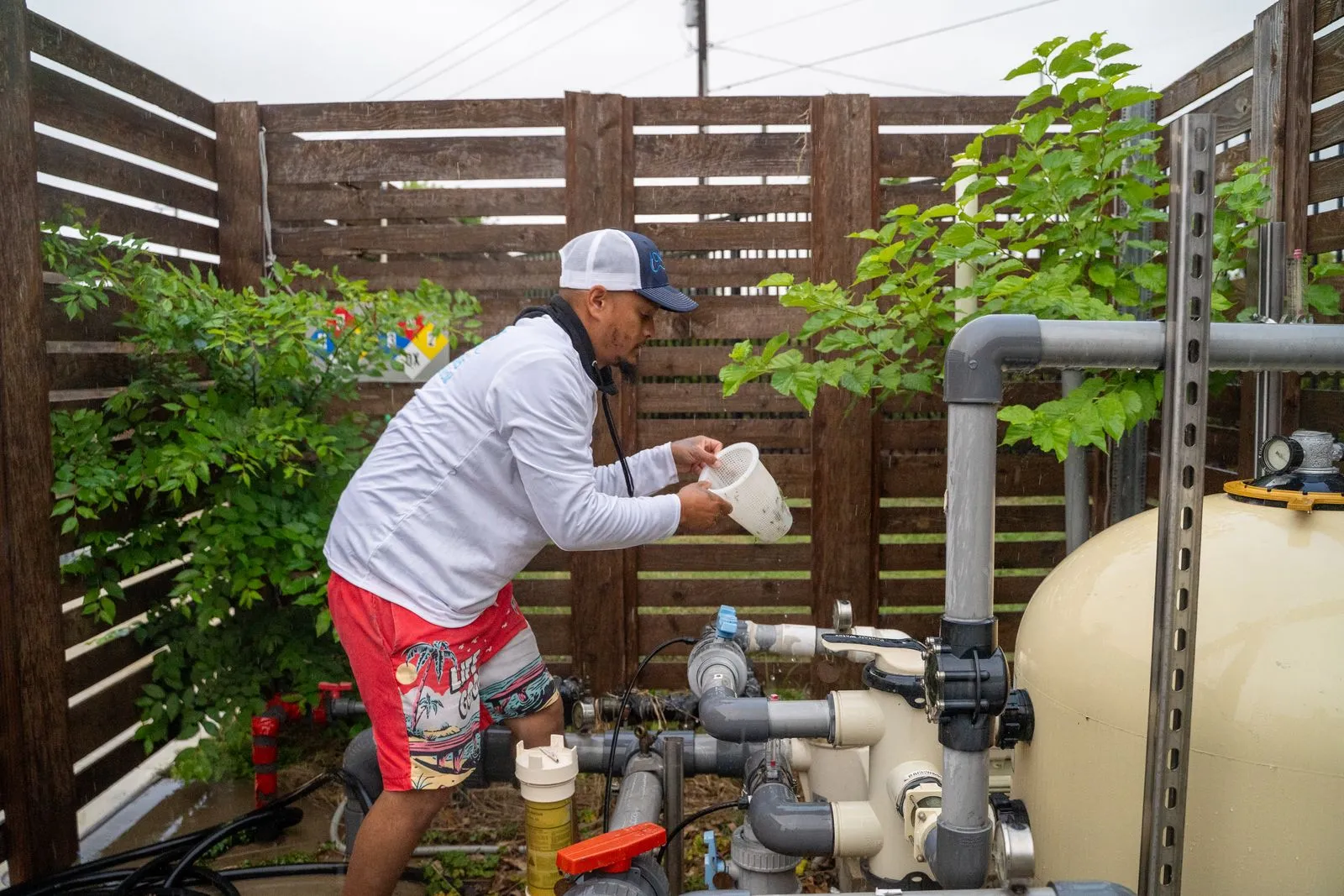 Pool technician adding chemicals to a commercial filtration system