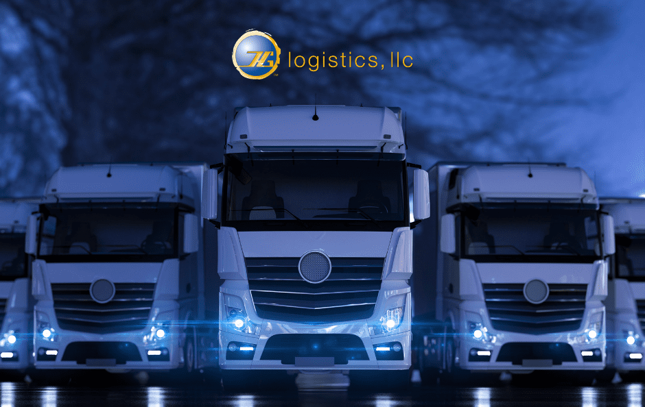 Row of white semi trucks with headlights on at night beneath the HG Logistics logo