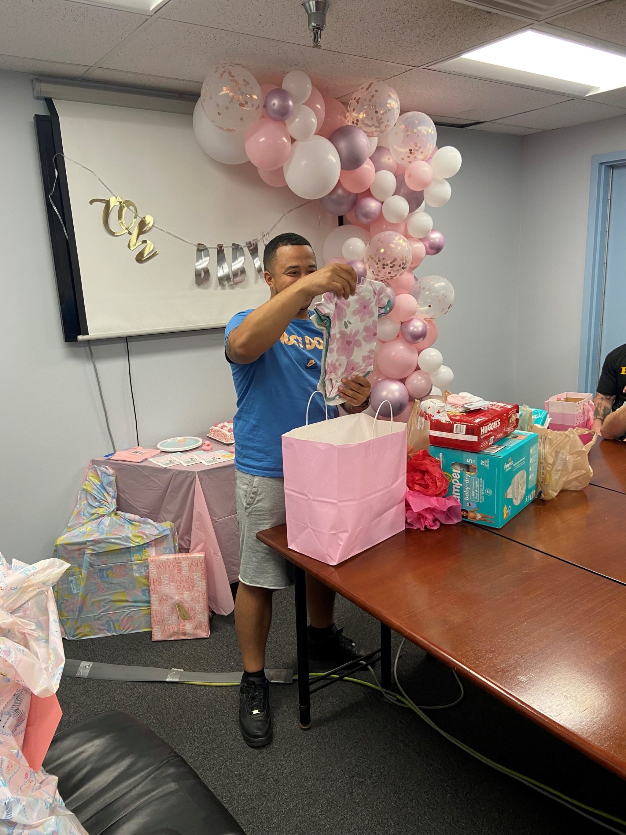 HG Logistics Showers Employee, Chris, with Baby Essentials