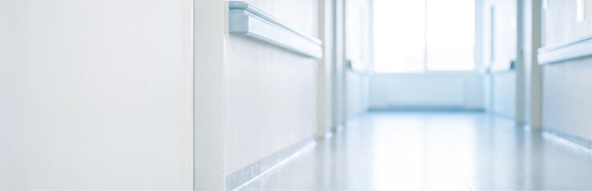 A hospital intensive care corridor, softly lit.