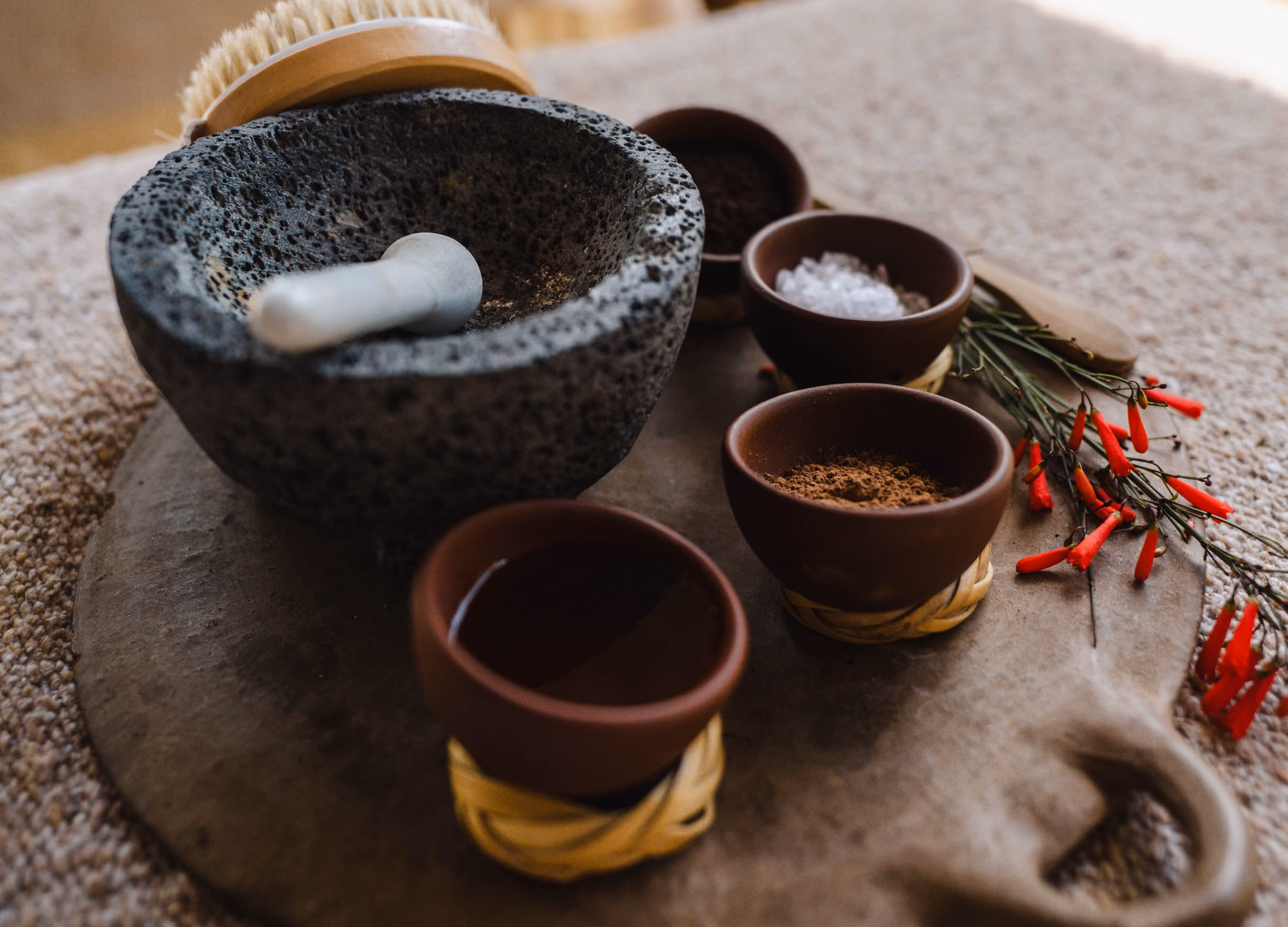 Stone molcajete with spices, salts and chiles for a spa ritual