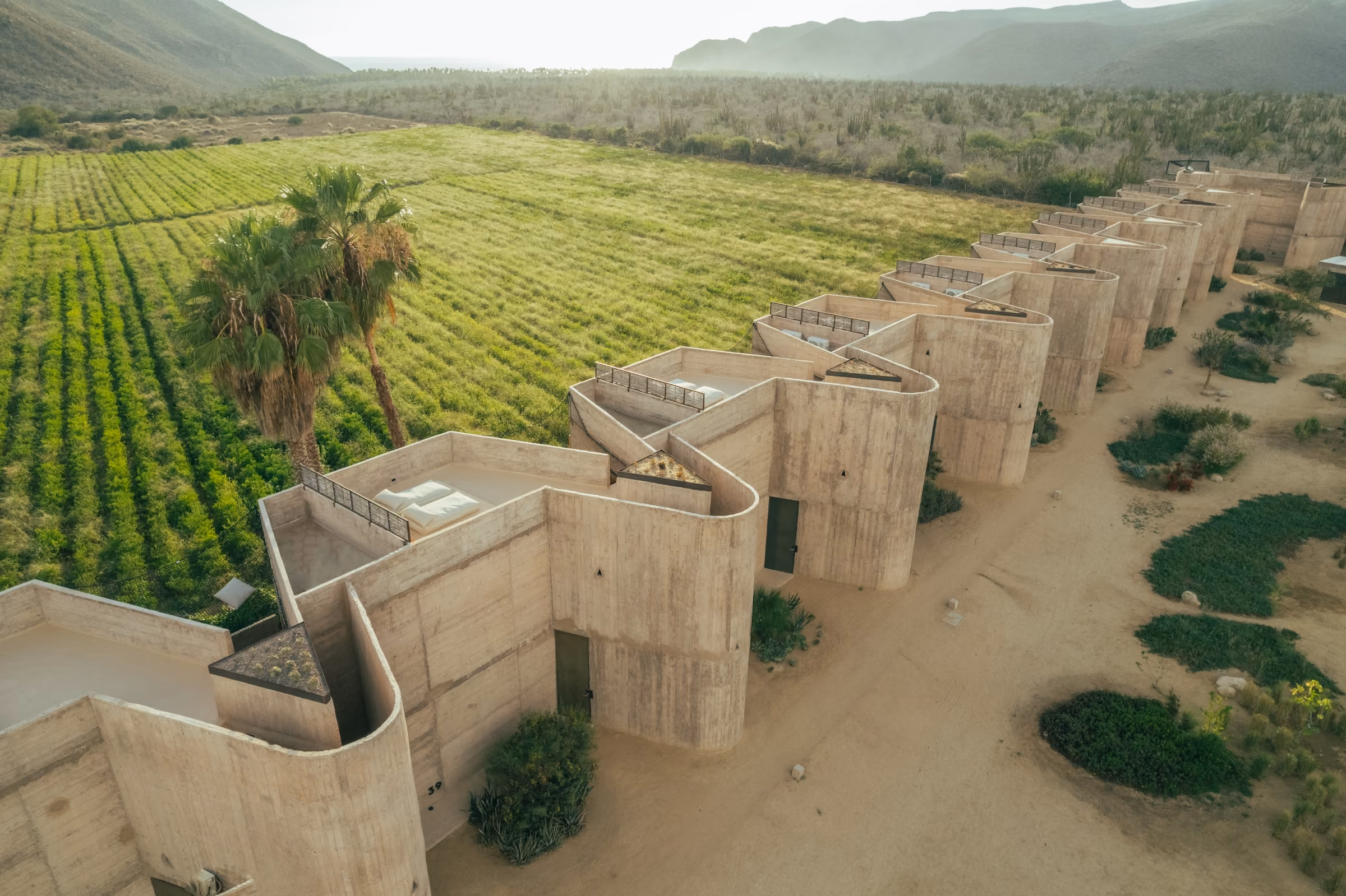 Aerial view of Paradero suites beside green farm fields
