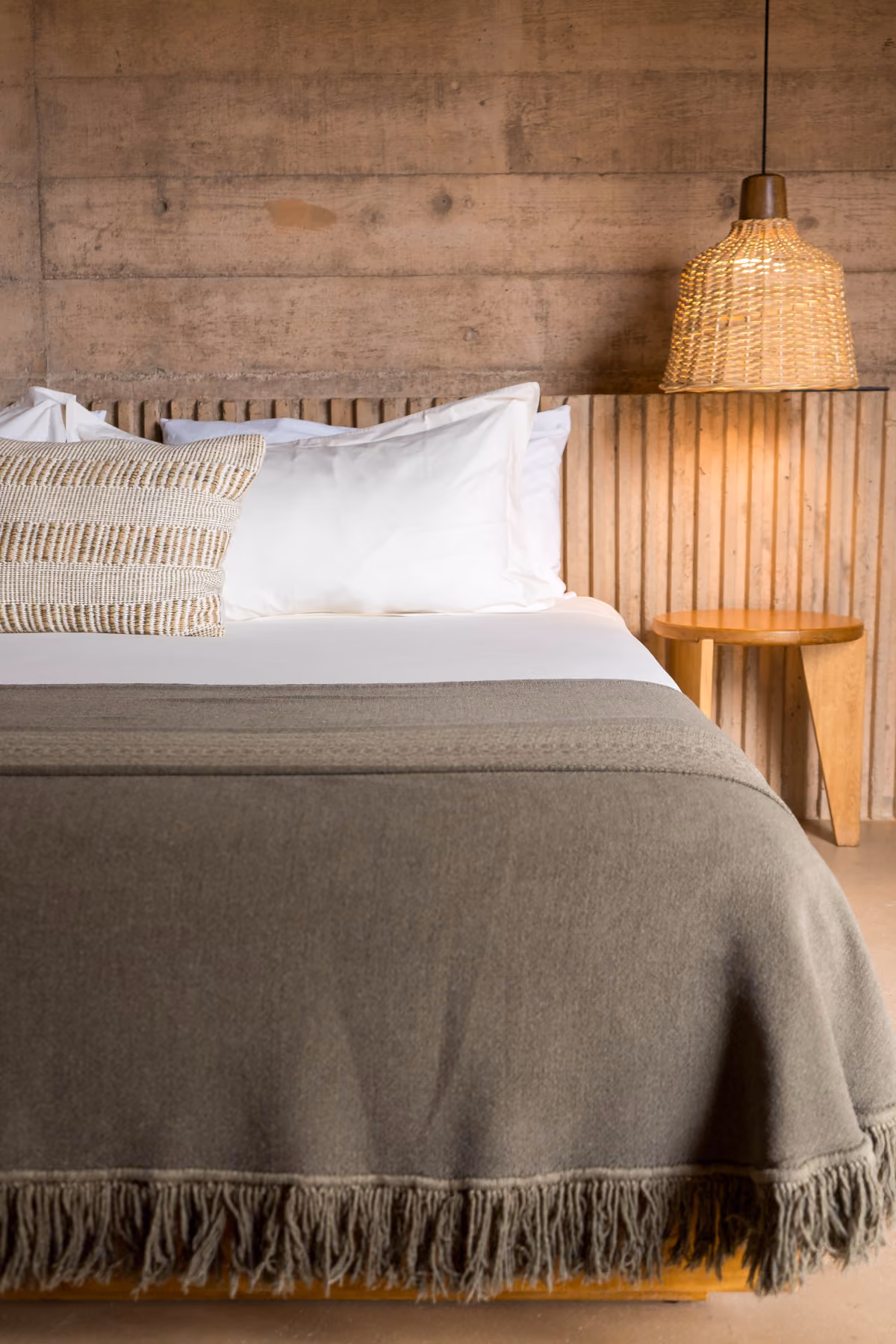 Suite bed with linen bedding and rattan pendant lamp