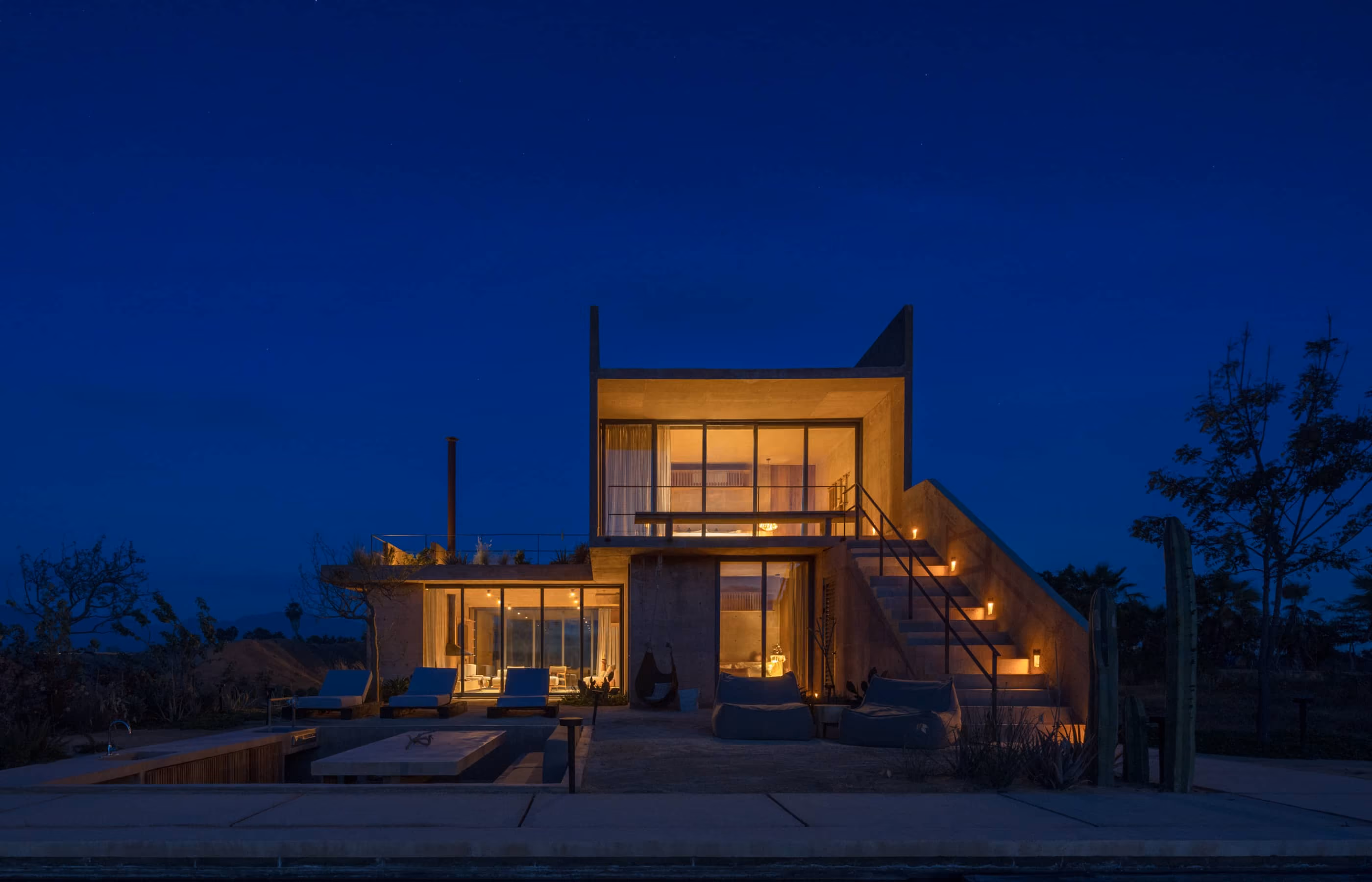 Villa with private pool illuminated at twilight
