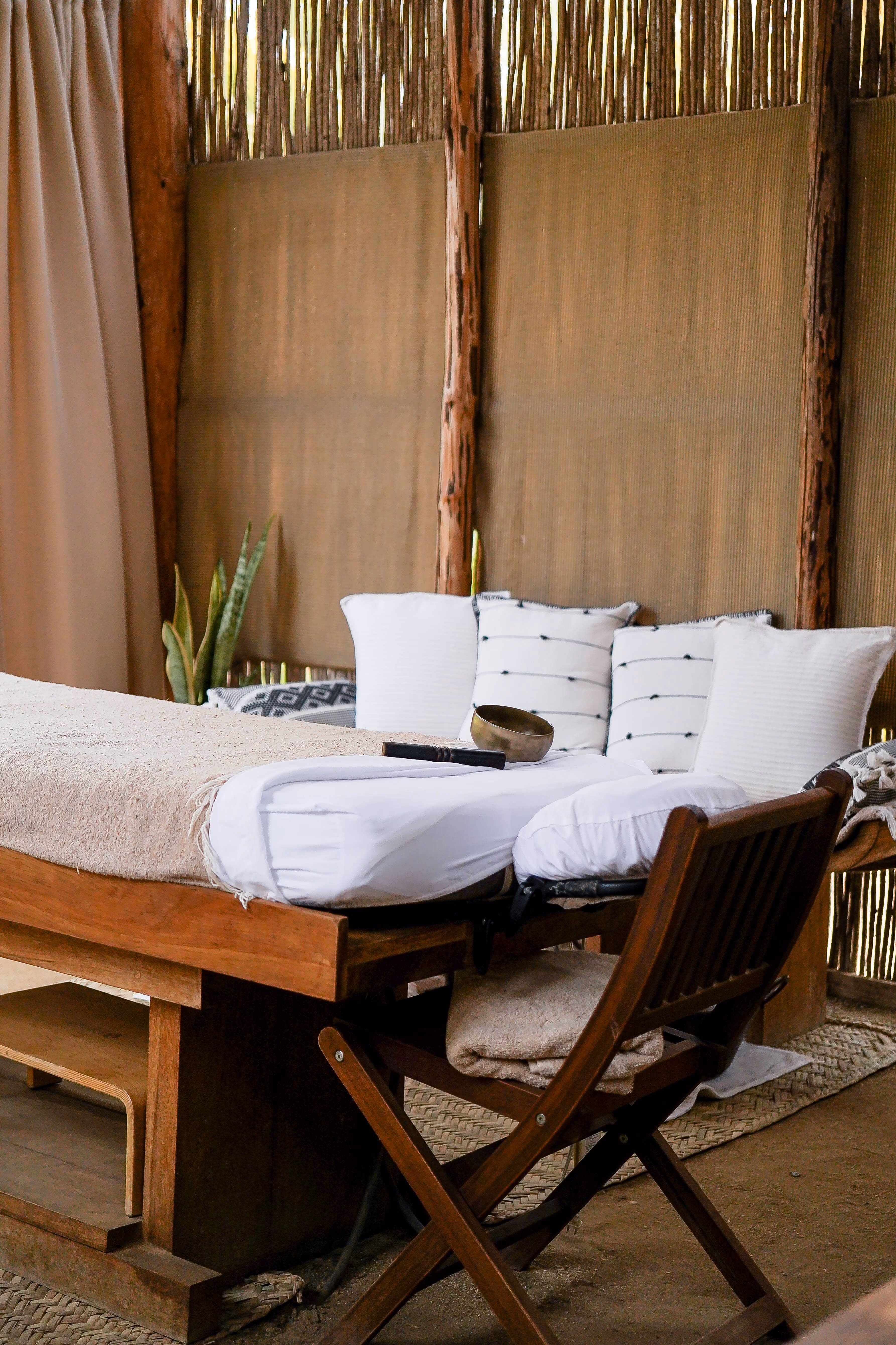 Suite bedroom with wooden desk and woven palm walls
