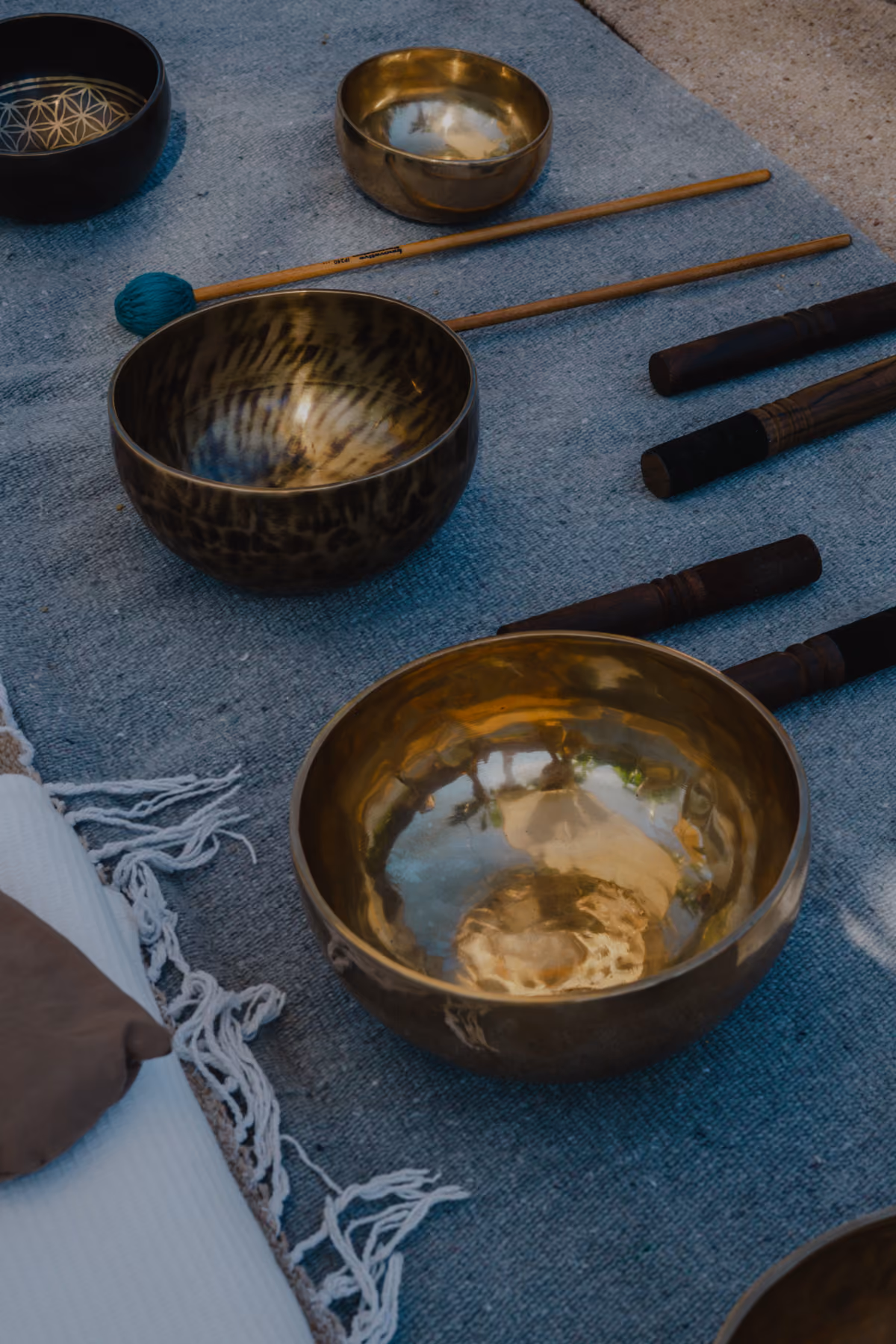 Tibetan singing bowls and mallets laid out for a sound bath