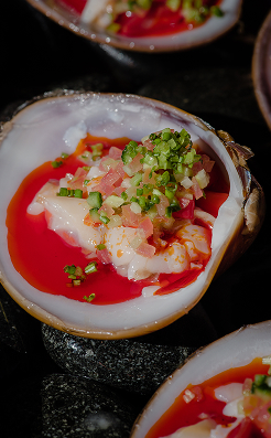 Raw fish crudo in a red chile sauce with herbs