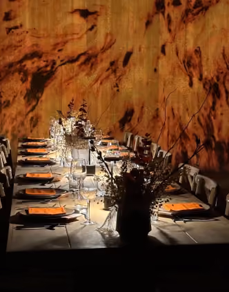 Candlelit long table dinner set for a private event