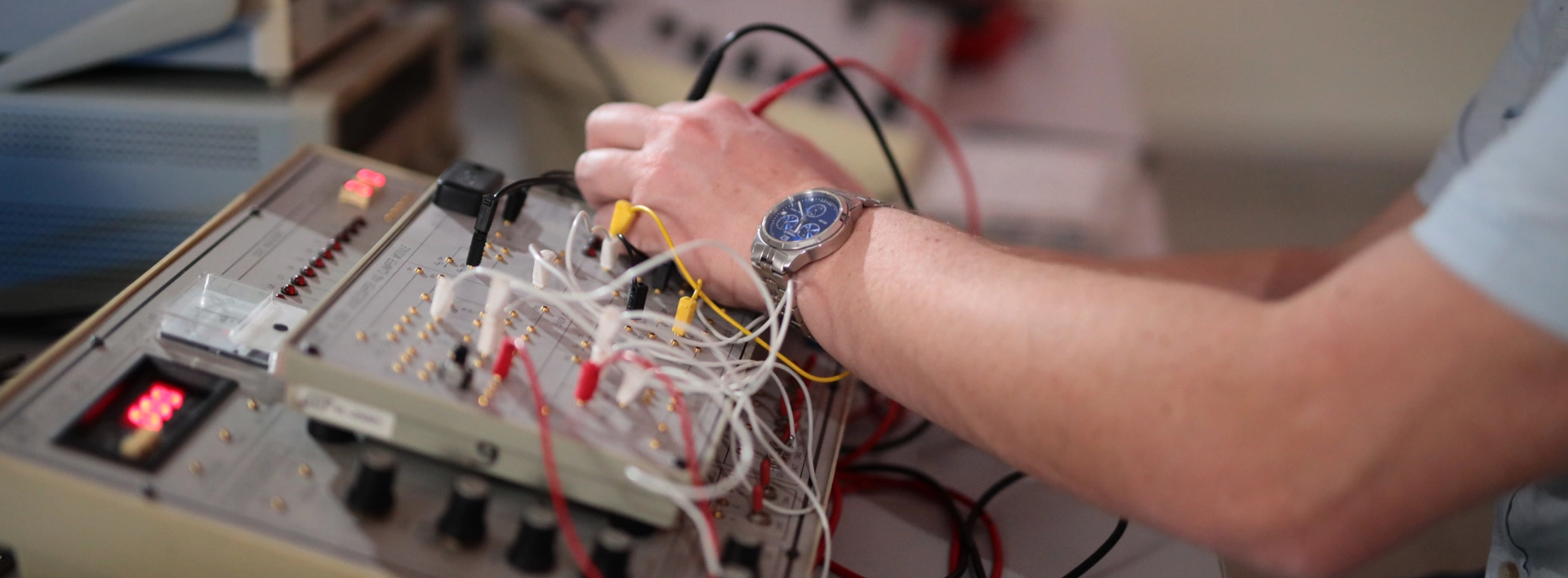 Student working on an electronics training board in an engineering lab