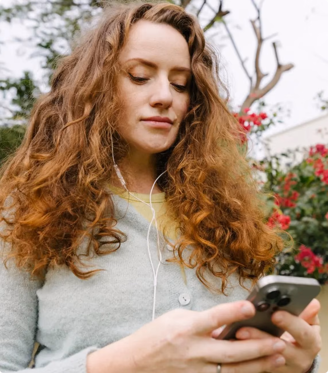Woman looking at her phone with chat notifications showing a billing dispute being escalated and transferred to tier-2 support.
