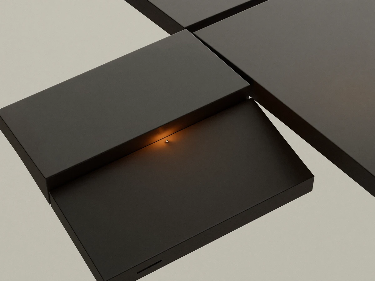 Dark stacked panels with a small glowing orange light