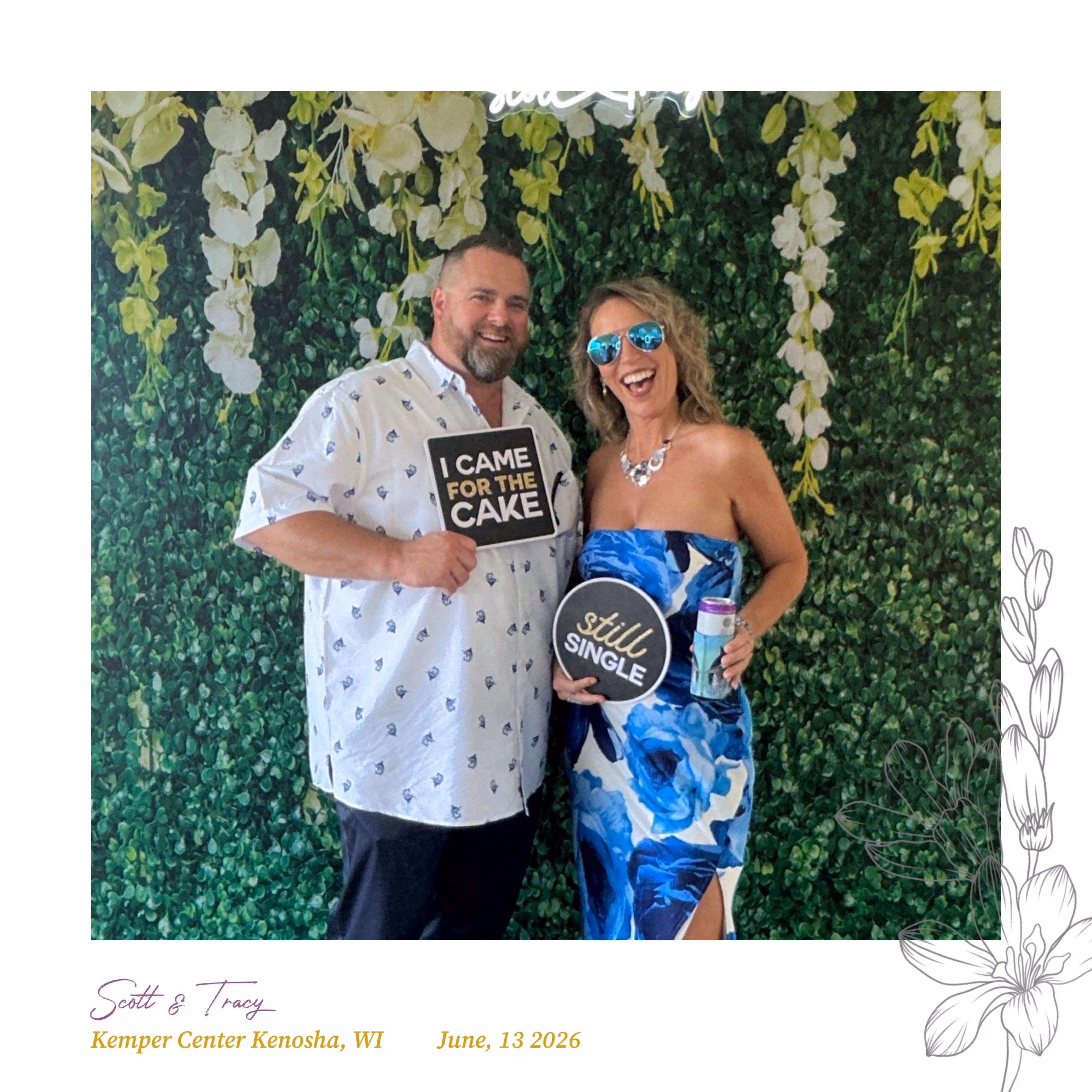 Bride and groom holding a photo strip in front of an illuminated oval photo booth at their wedding reception