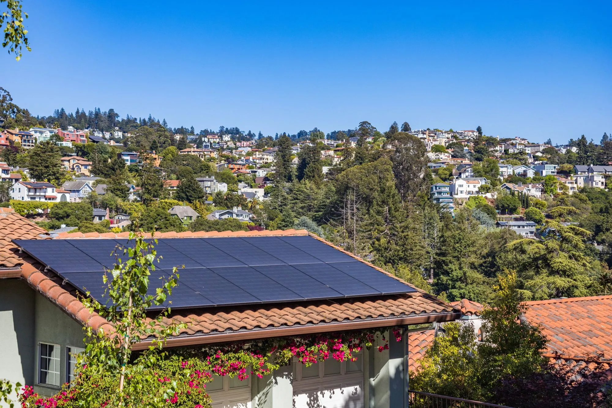 Home with rooftop solar panels exposed to the elements