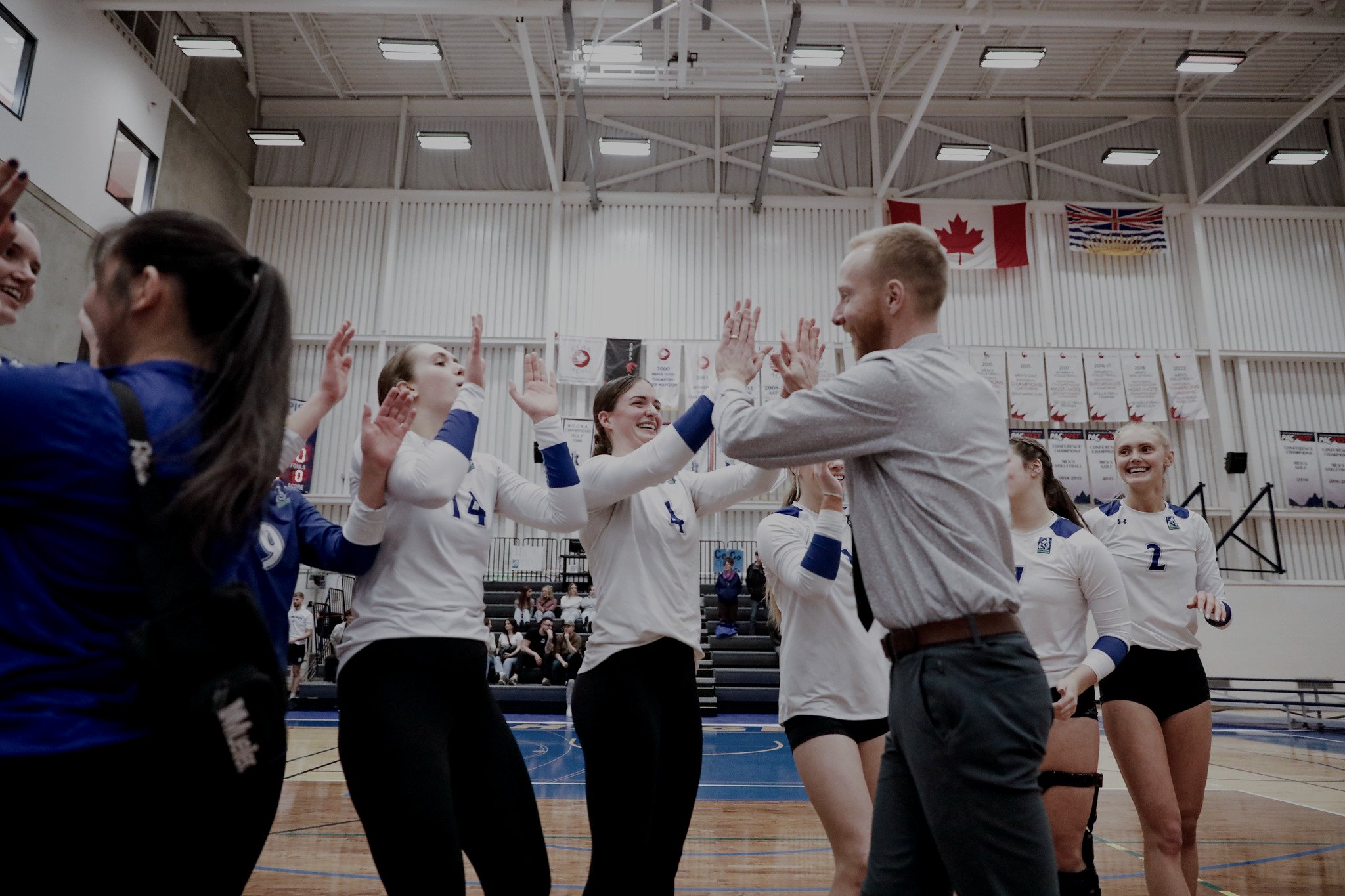 Brent high-fiving Camosun Chargers players on court