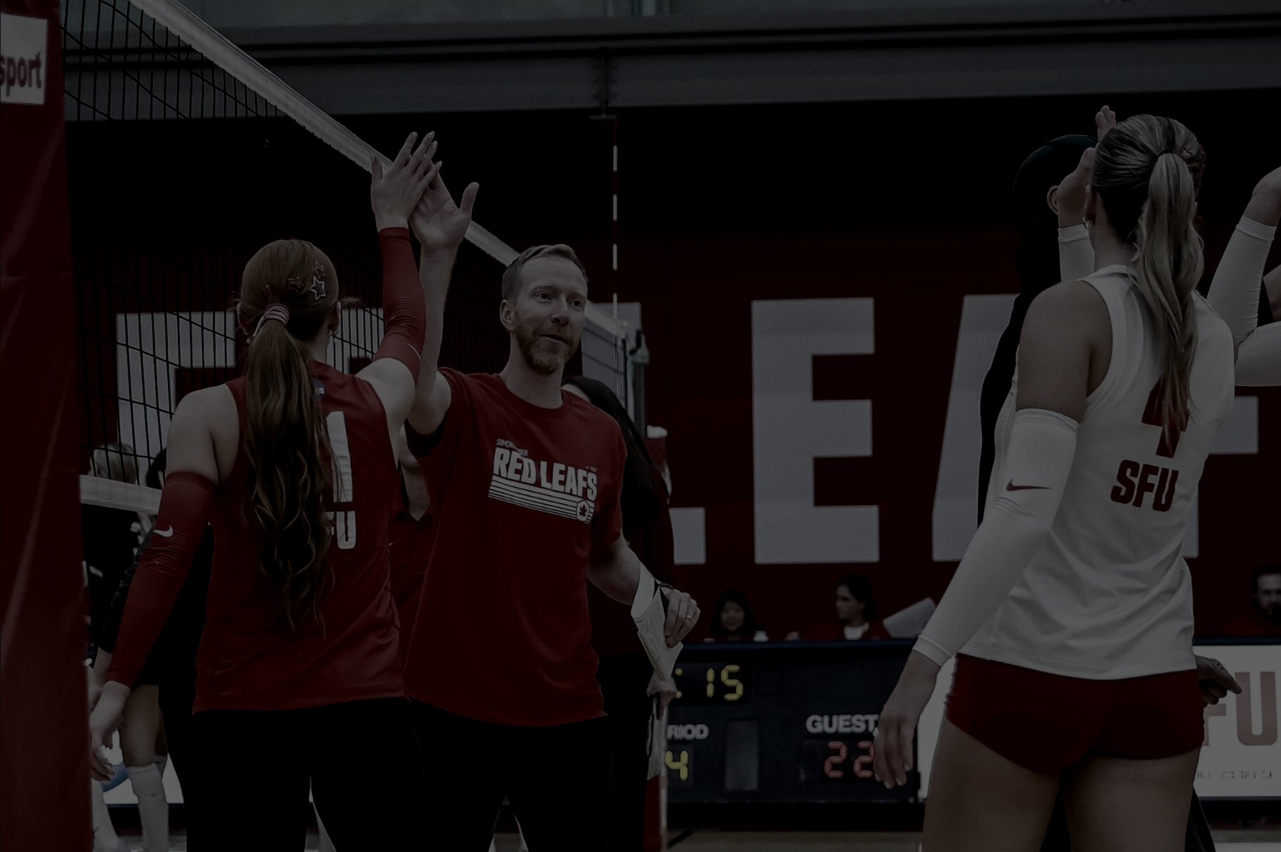 Brent celebrating with players with a high-five