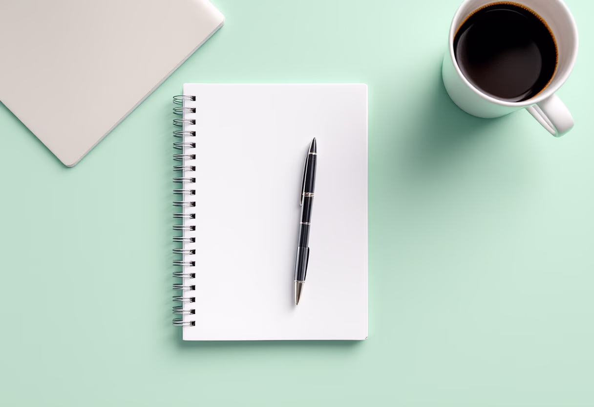 image of a notebook and a coffee cup on a desk