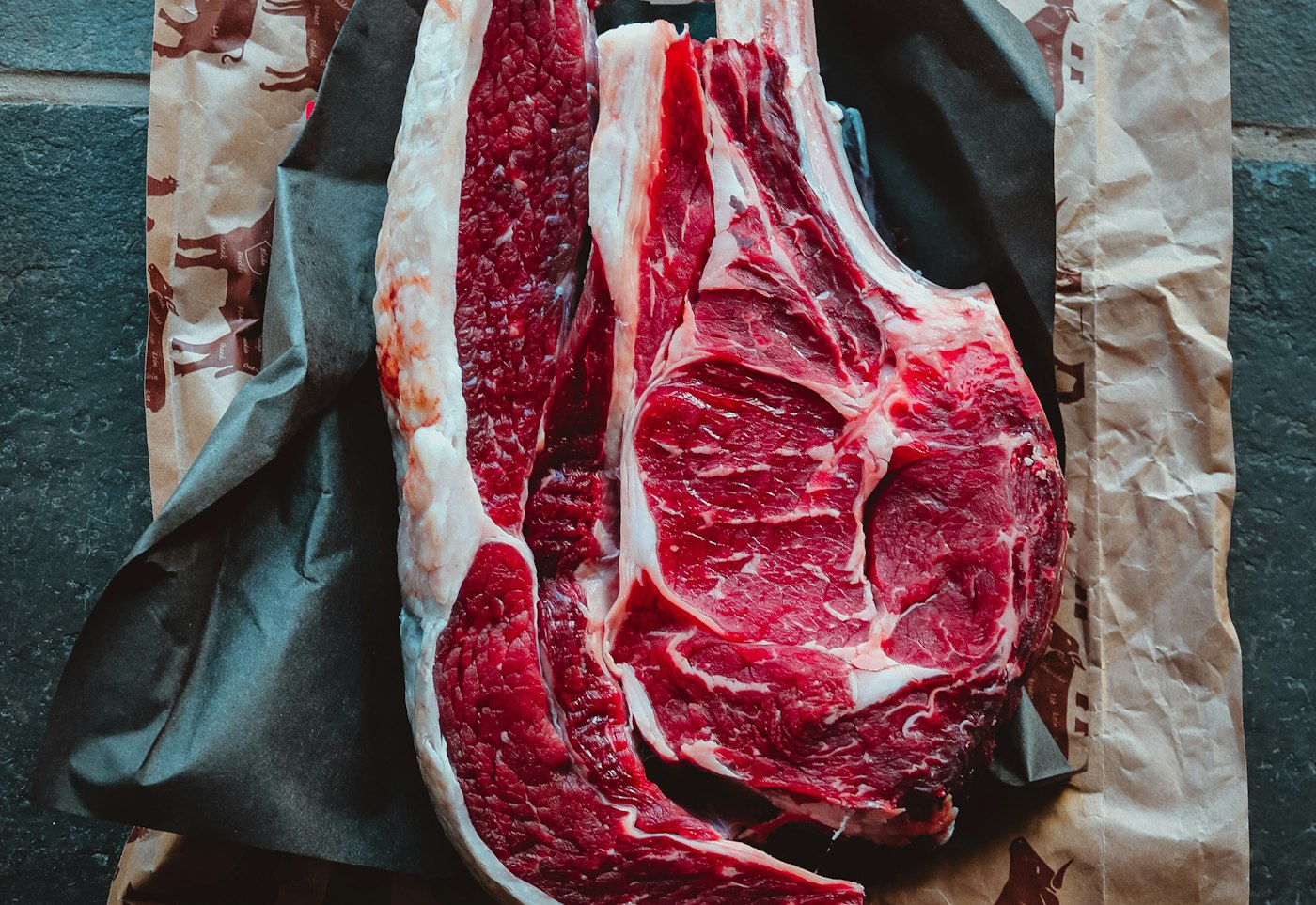 A fresh cut of raw beef on butcher paper