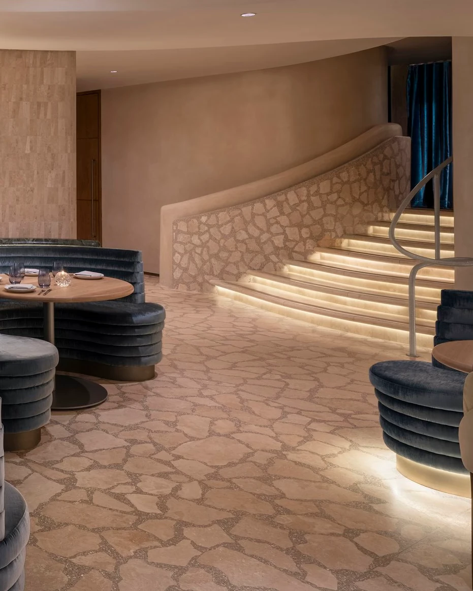 Point Seven restaurant interior with custom palladiana terrazzo flooring and illuminated stair in New York.