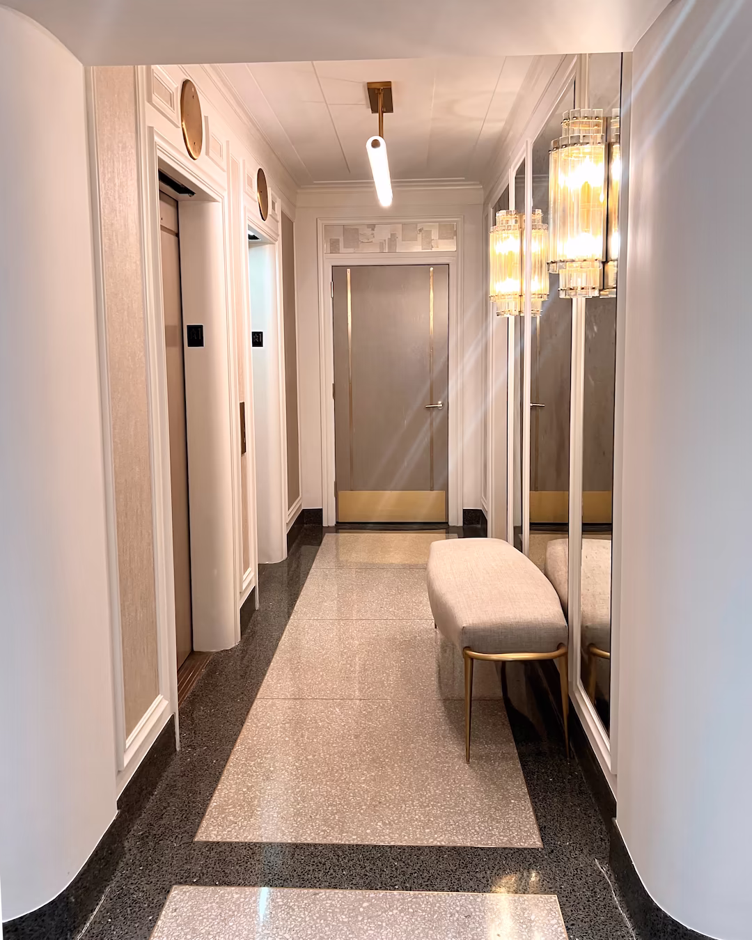 Shore Towers lounge with custom epoxy terrazzo flooring, architectural model, artwork, and leather seating.